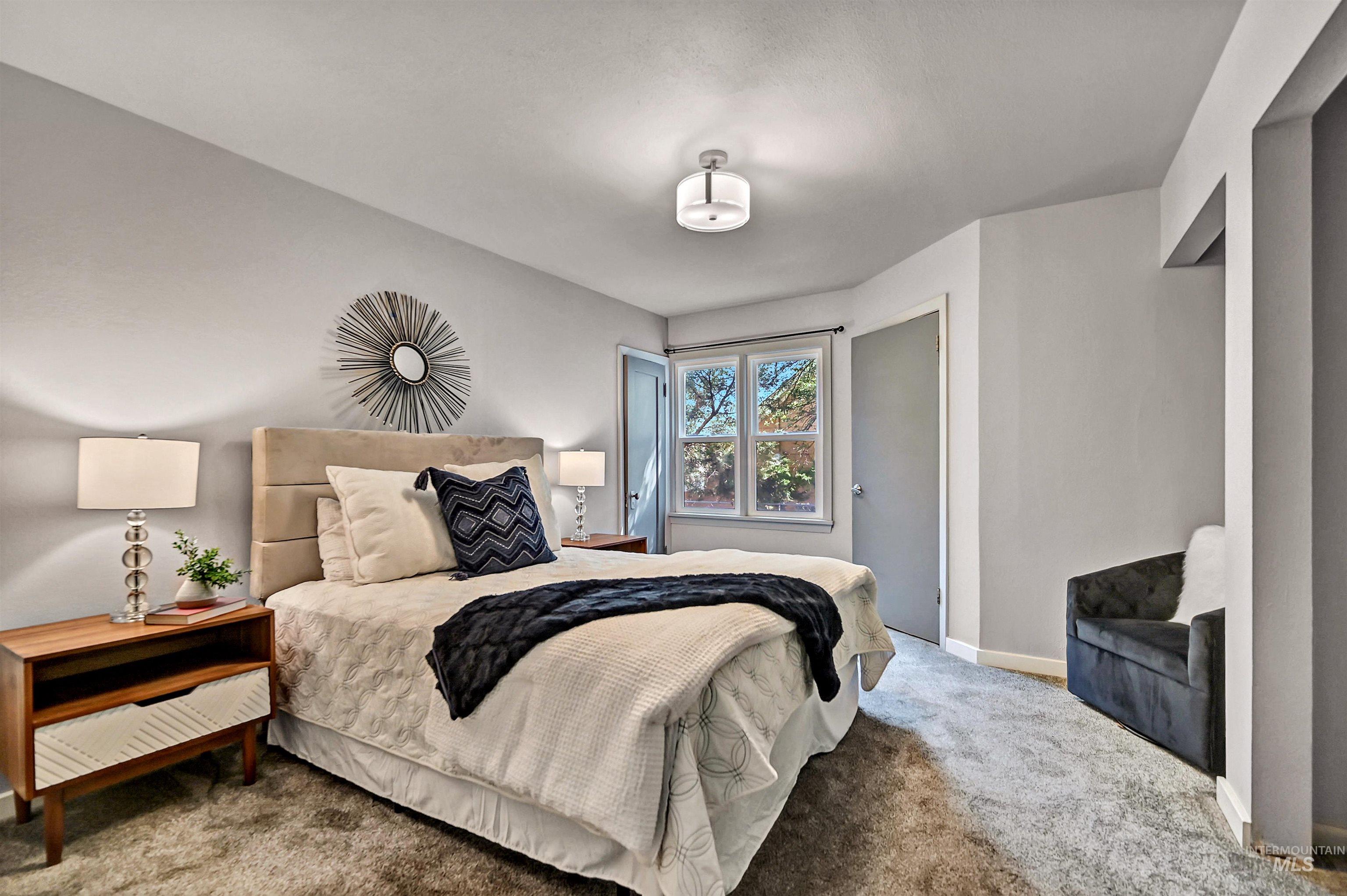 Carpeted bedroom featuring baseboards