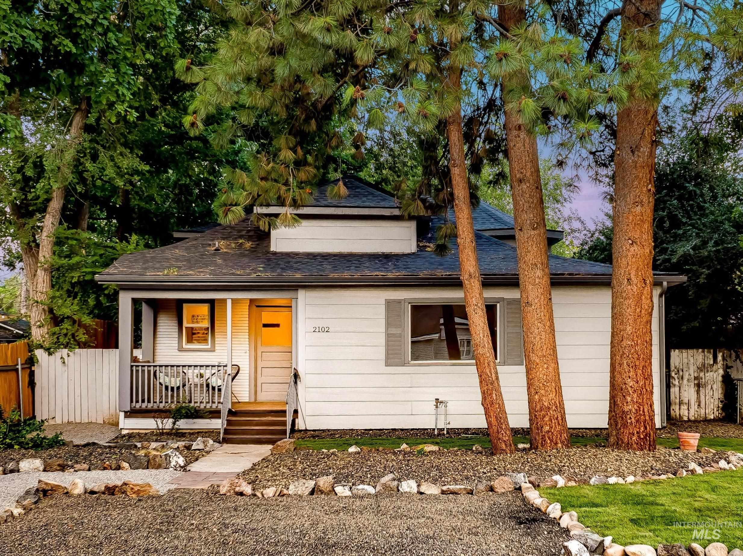 View of front of home featuring covered porch and roof with shingles
