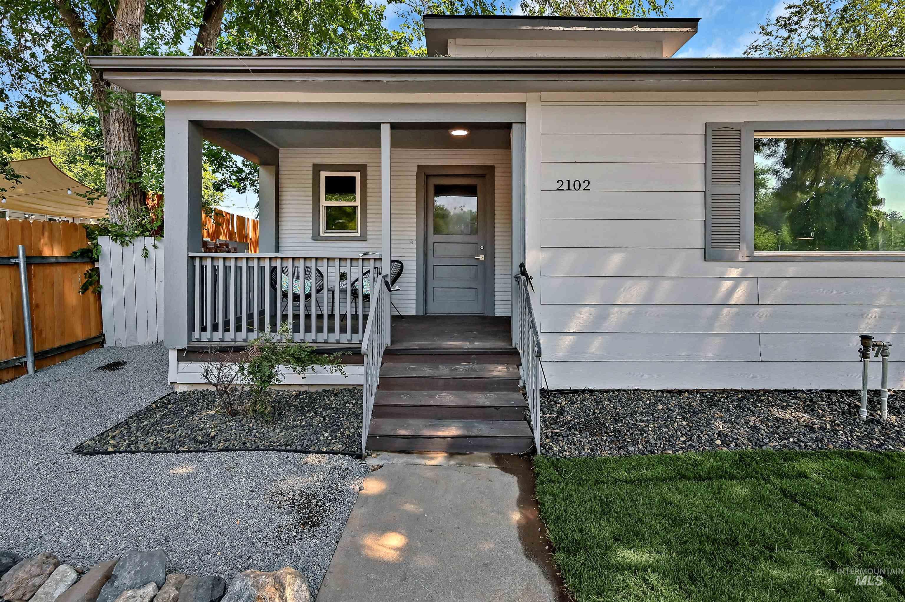 Property entrance featuring a porch and lawncare items