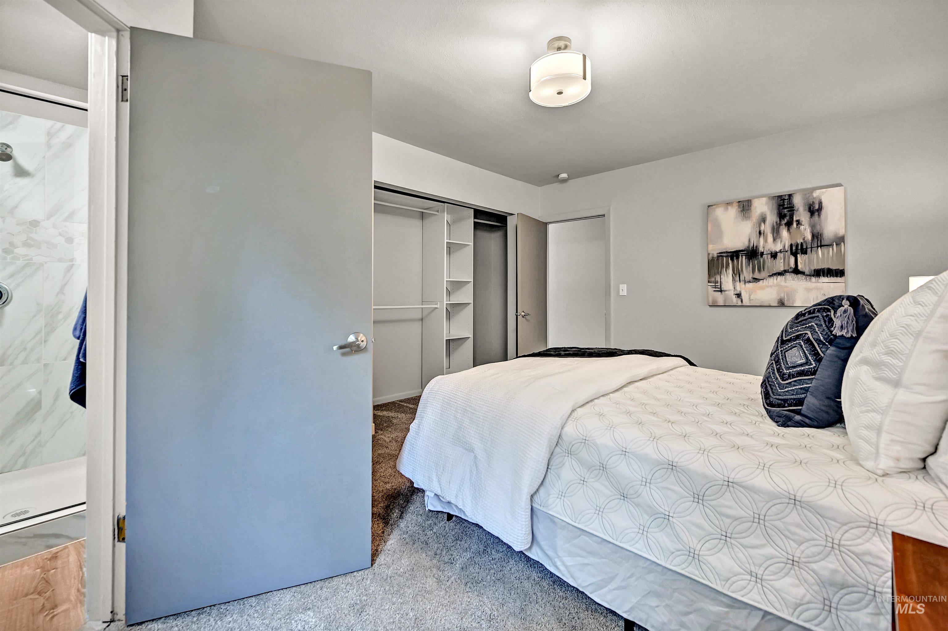 Bedroom featuring carpet and a closet