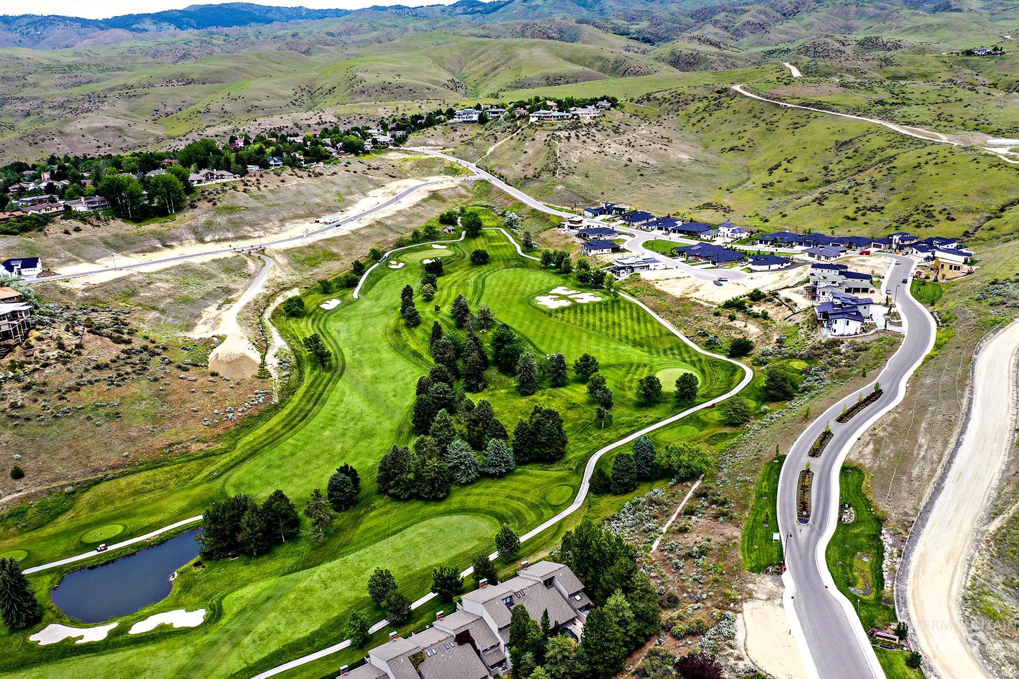 Aerial view of residential area featuring mountains and a local golf course