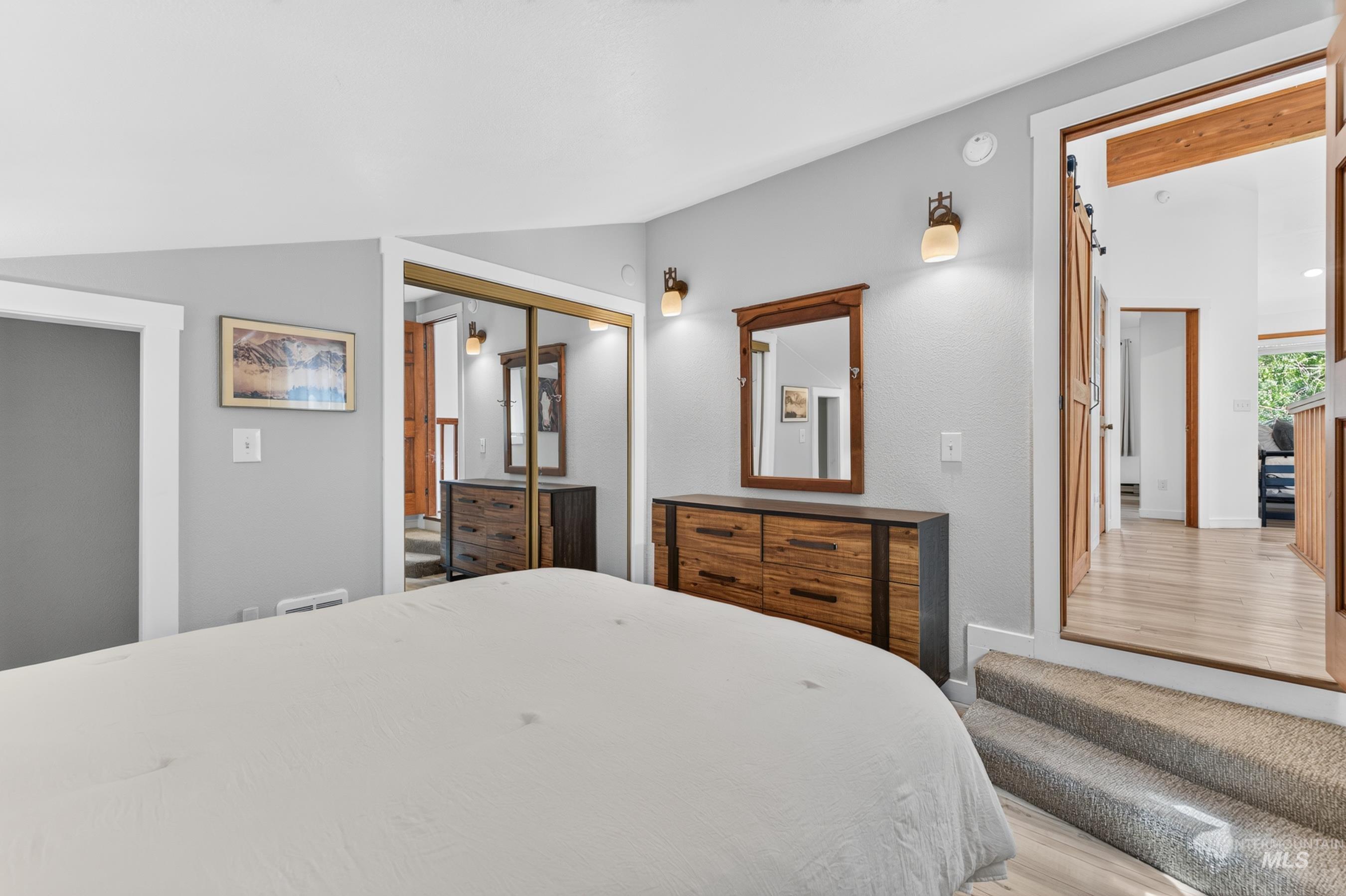 Bedroom featuring a vaulted ceiling and light gray walls