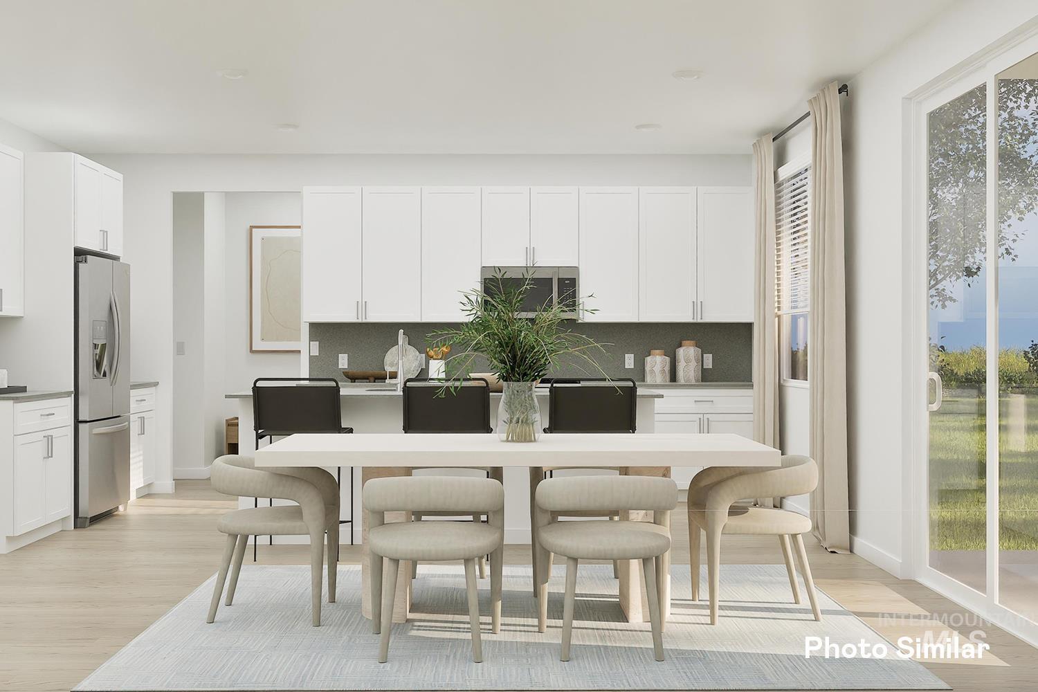 Kitchen featuring light wood-style flooring, backsplash, stainless steel appliances, and white cabinetry
