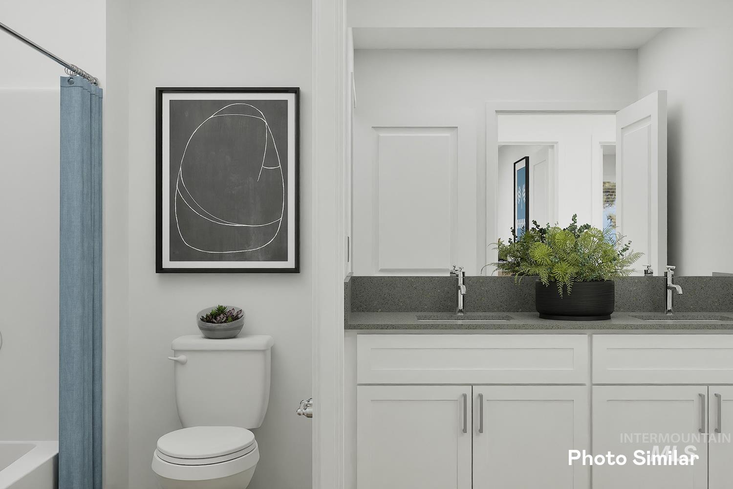 Bathroom featuring double vanity and toilet