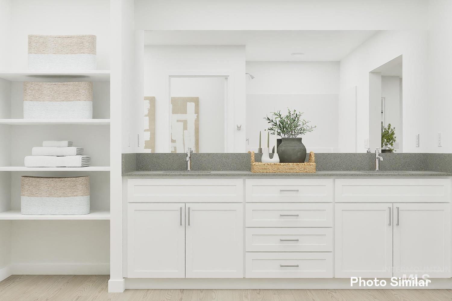 Bathroom with double vanity and wood finished floors