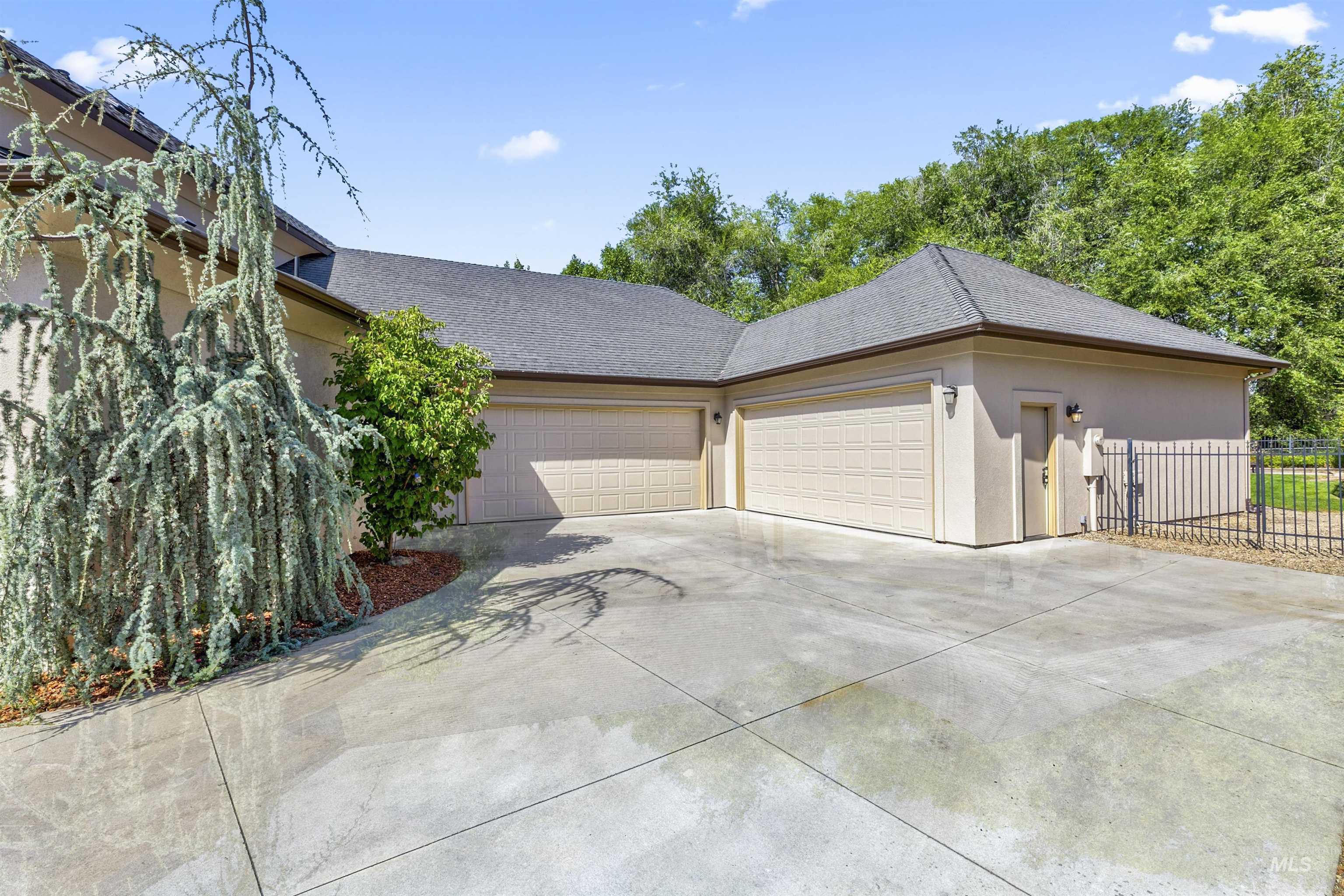 View of home's exterior featuring stucco siding, concrete driveway, a shingled roof, and an attached garage