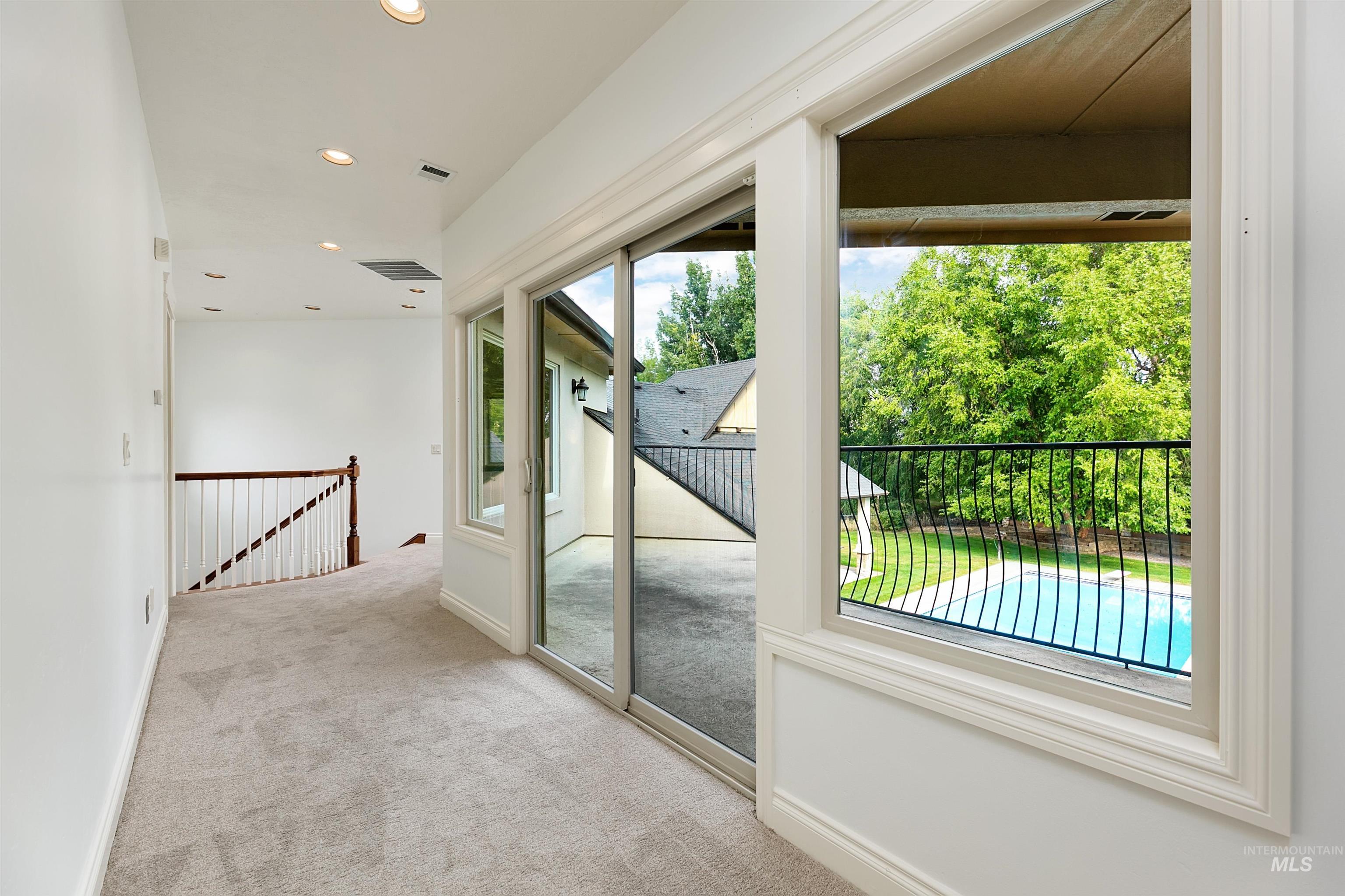 Doorway featuring carpet floors and recessed lighting