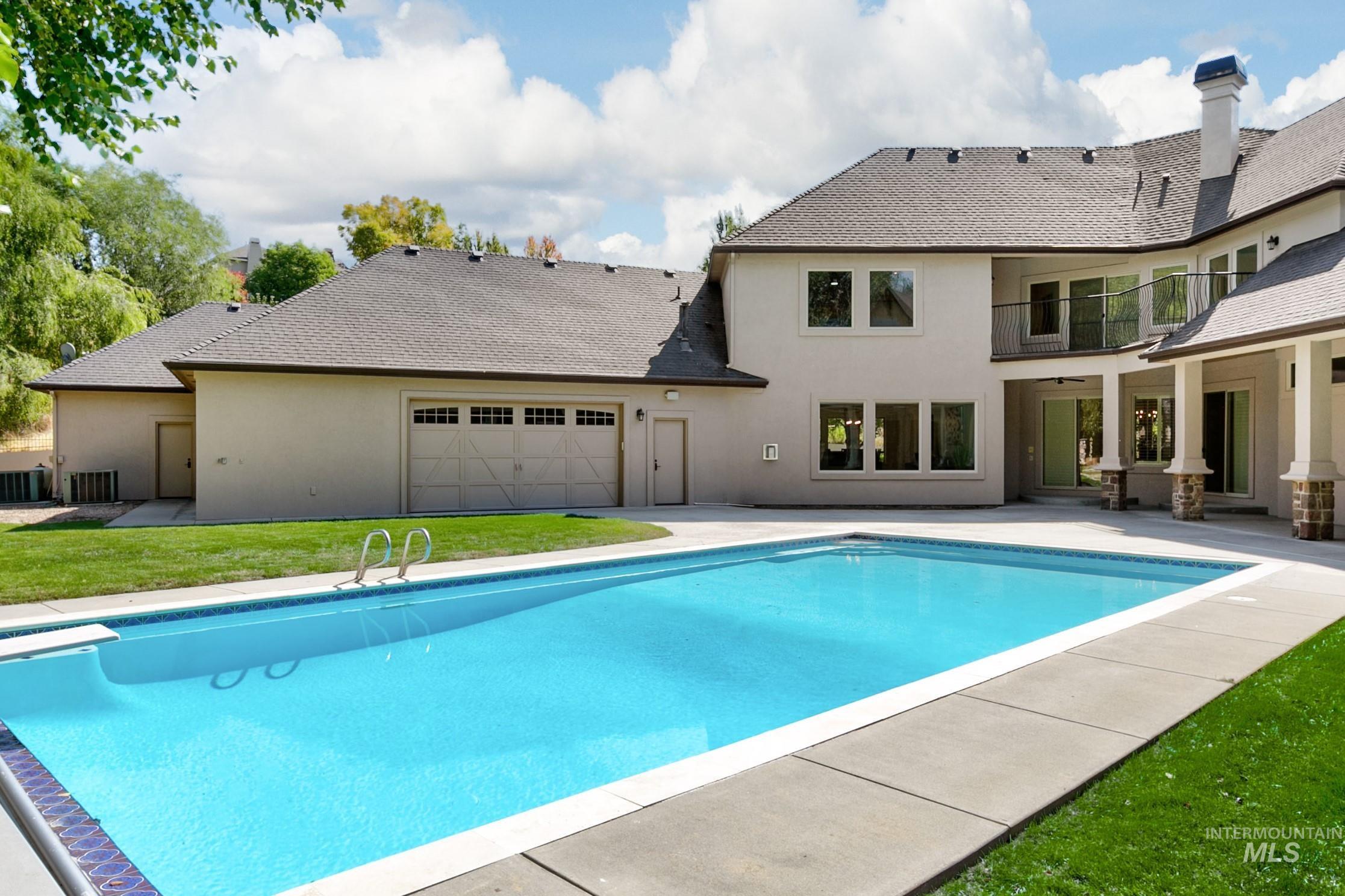 View of pool with a patio, a lawn, and a ceiling fan