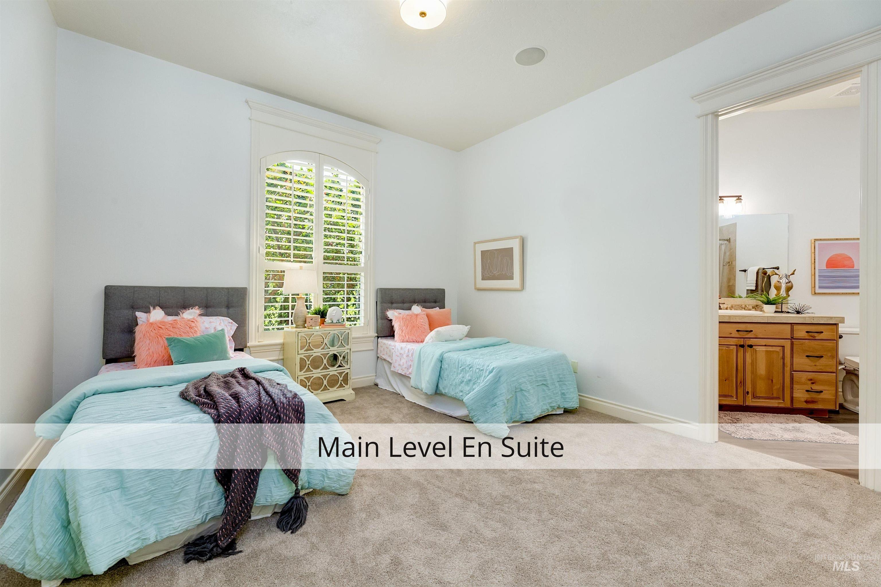 Bedroom with light colored carpet and ensuite bath