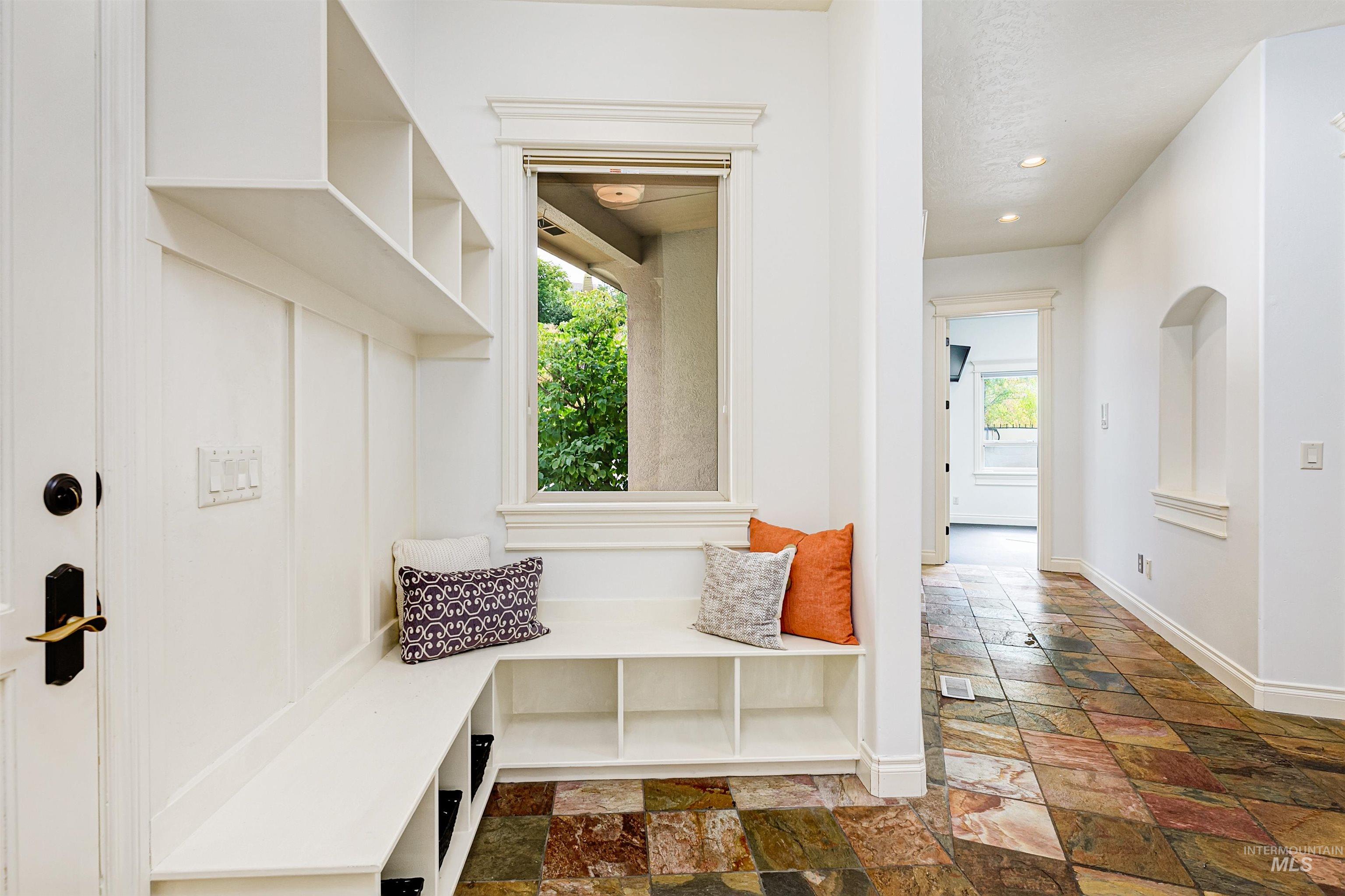 Mudroom with stone tile flooring and recessed lighting