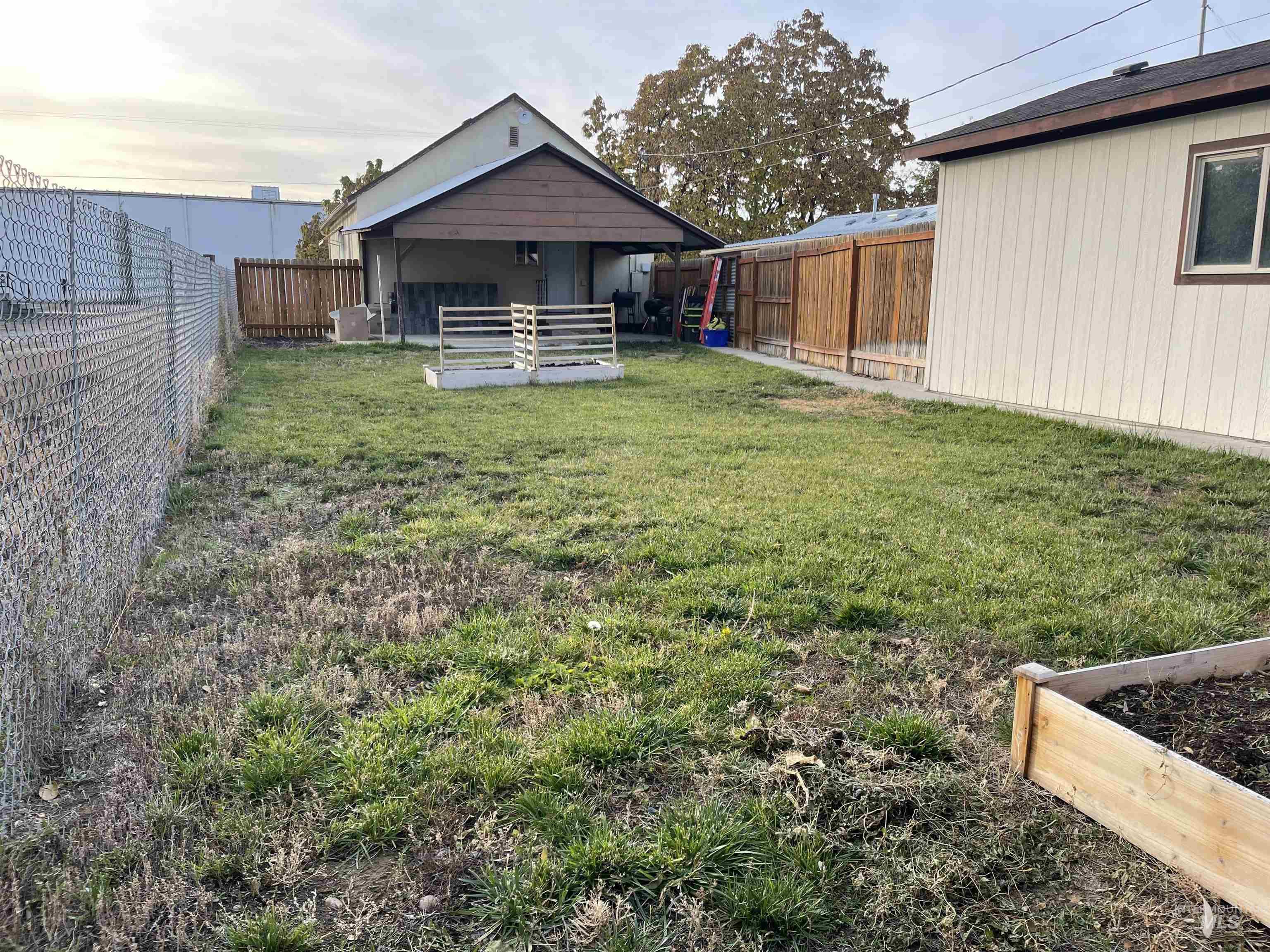 Fenced backyard with a garden