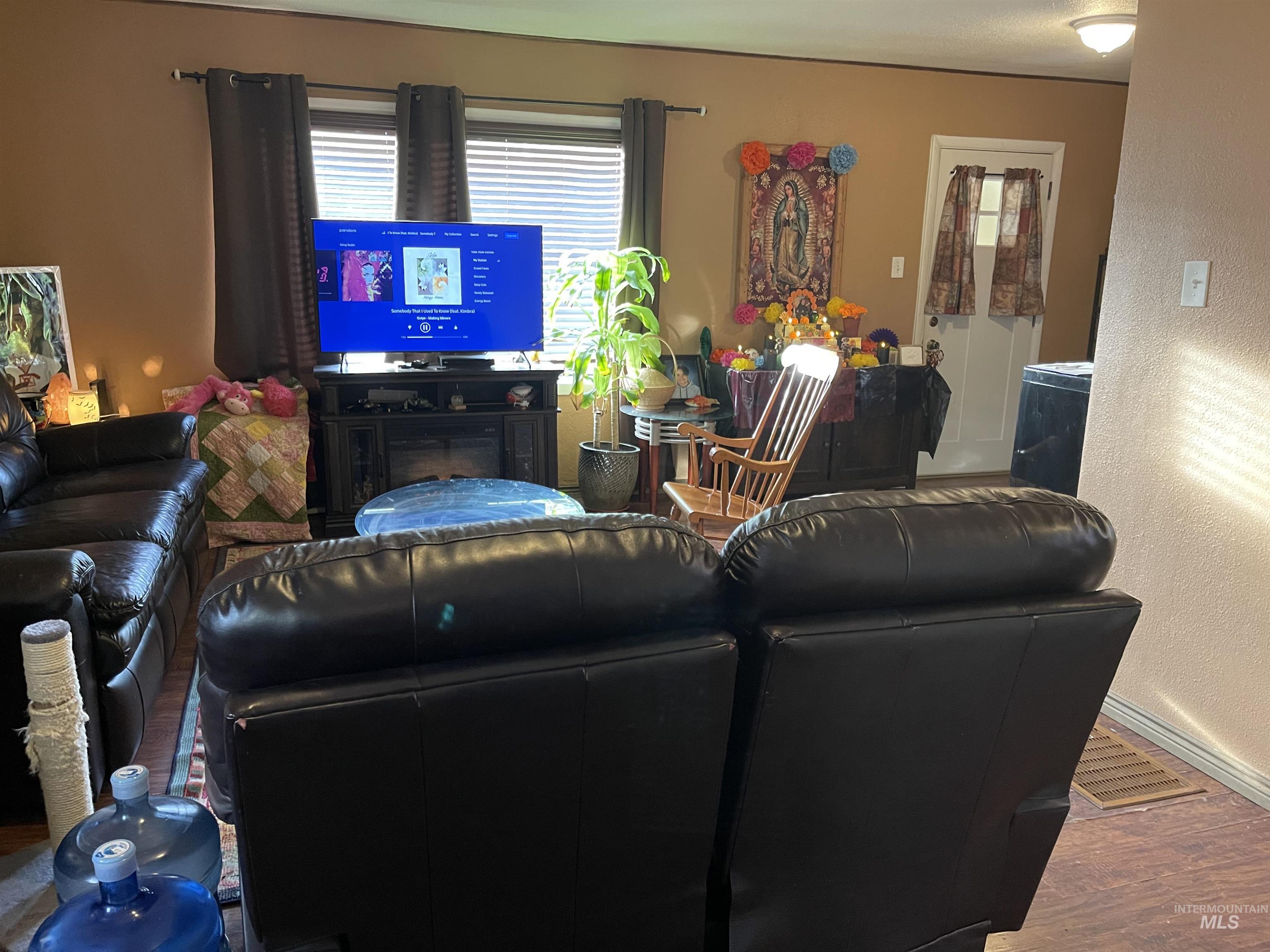 Living room with a textured wall and wood finished floors