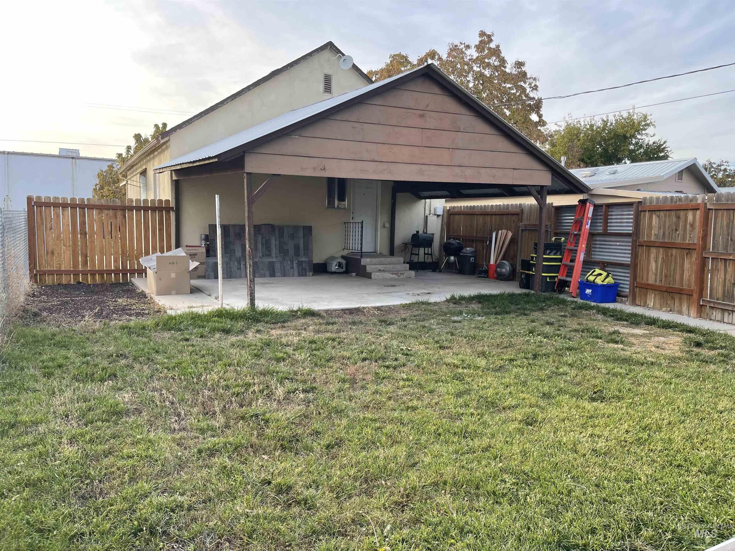 Back of house with a fenced backyard, a patio area, and stucco siding