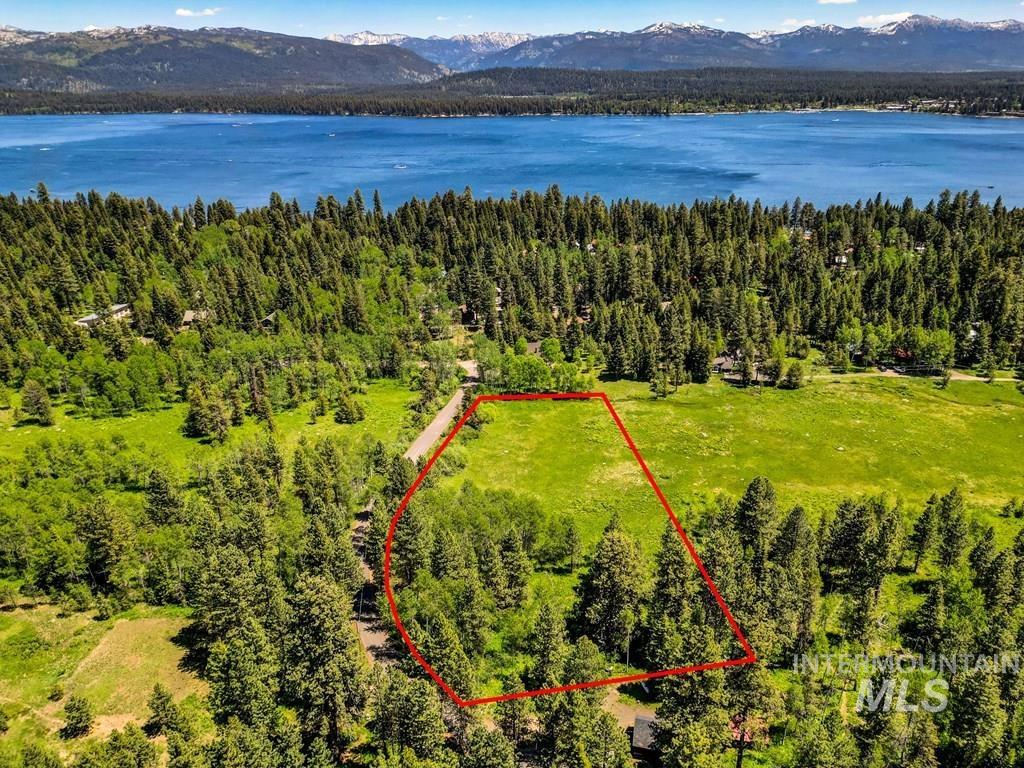 View of property location with property parcel outlined and a water and mountain view