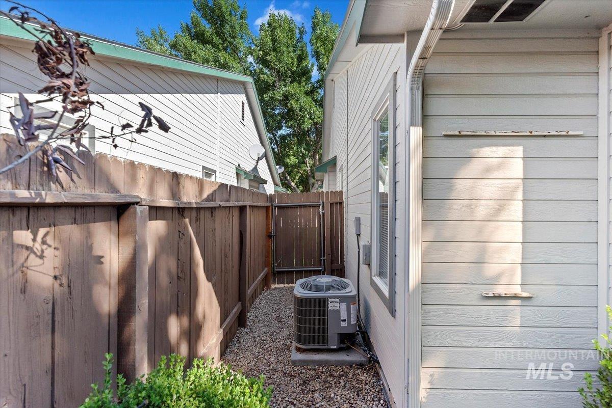 View of side of property with a cooling unit