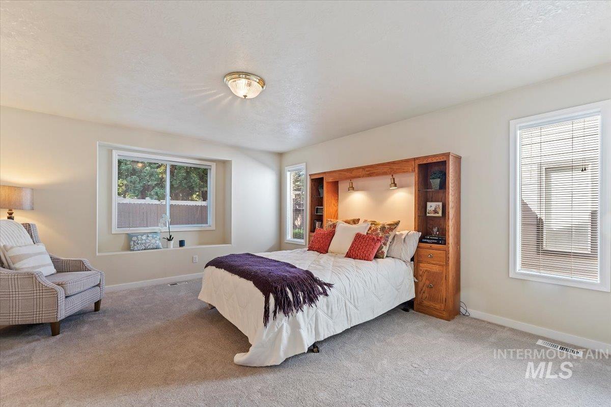 Bedroom with carpet floors and a textured ceiling
