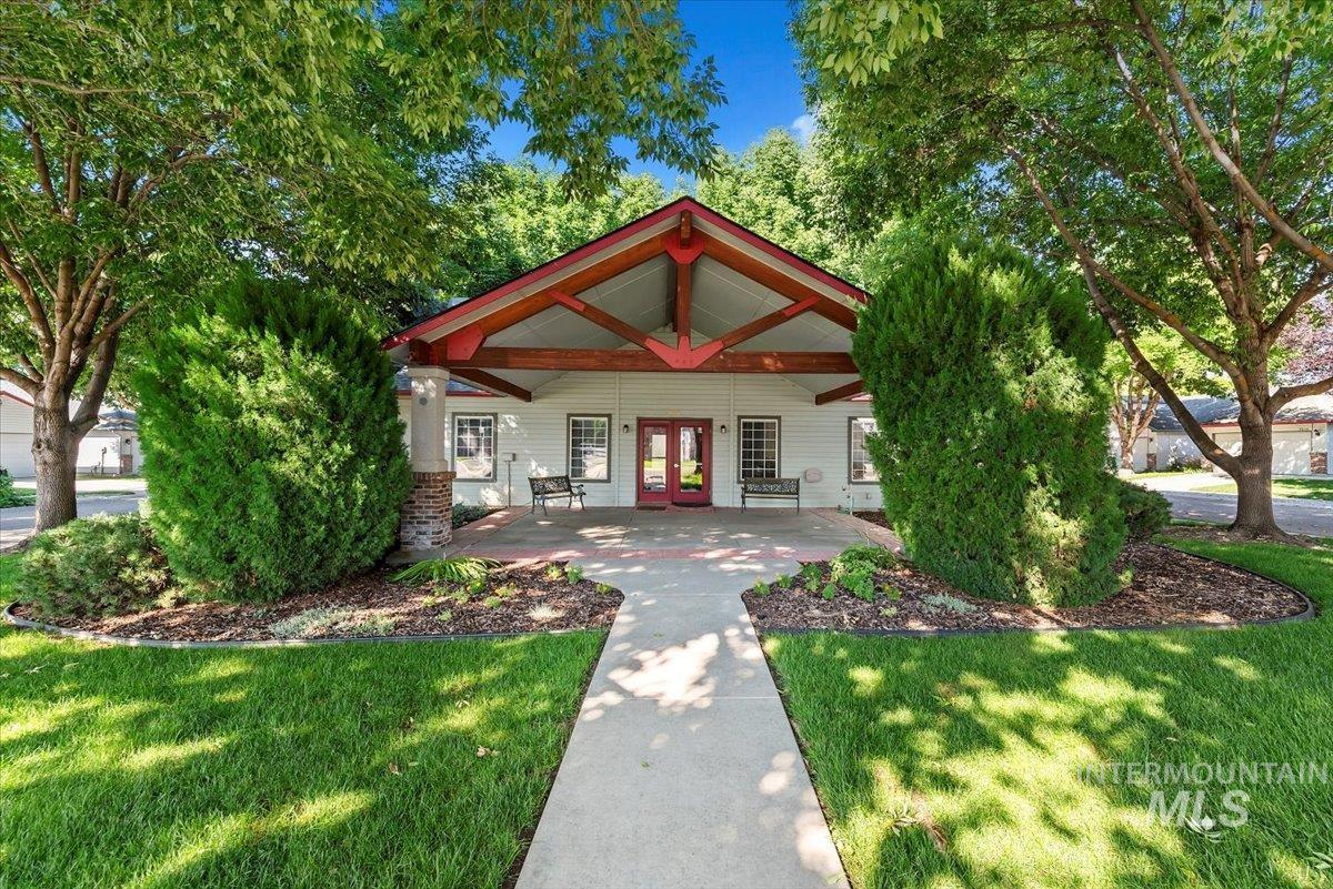View of front of house featuring french doors, covered porch, and a front lawn