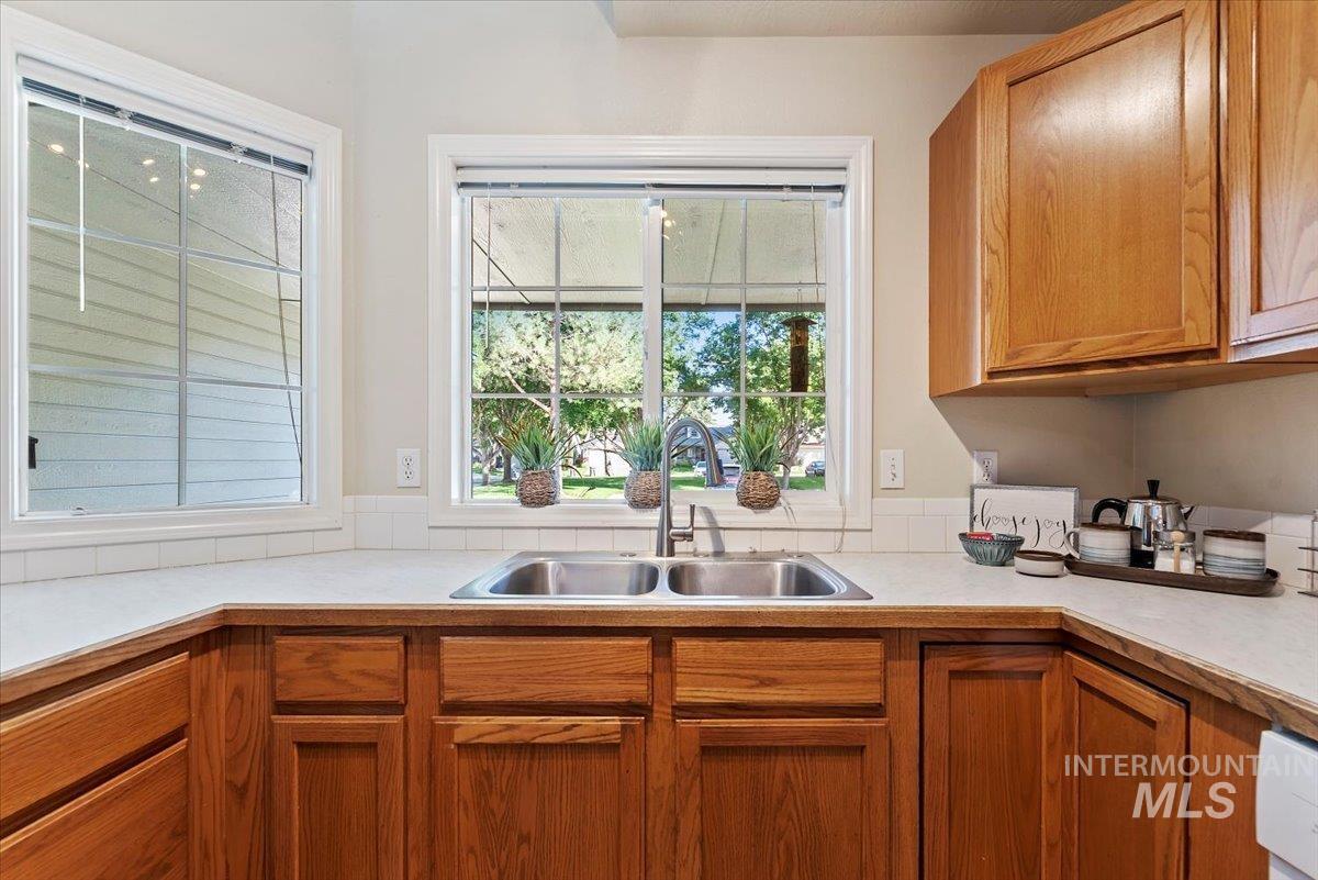 Kitchen featuring light countertops and brown cabinetry