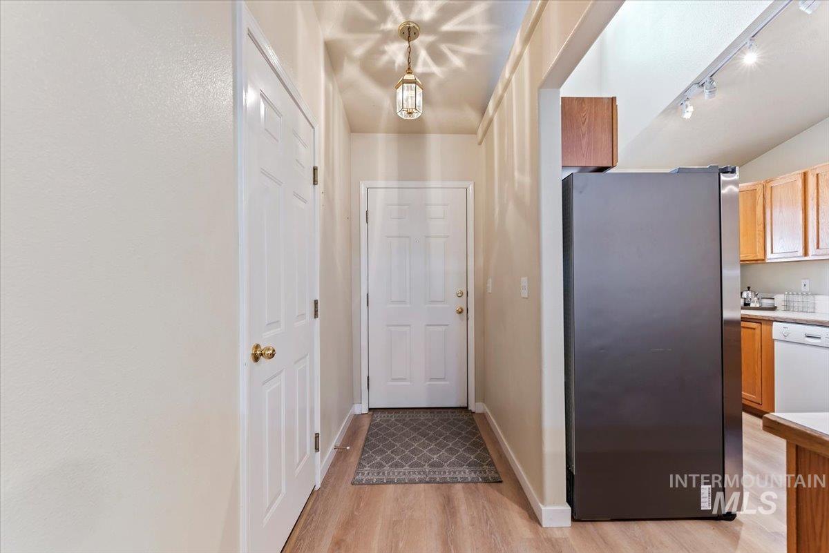 Entryway featuring wood finished floors and rail lighting