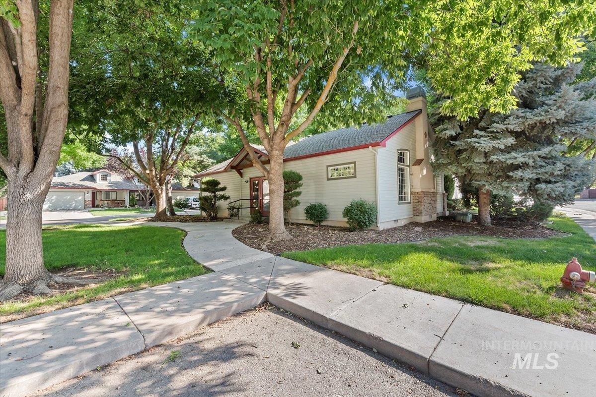 View of front facade featuring a front lawn and a chimney