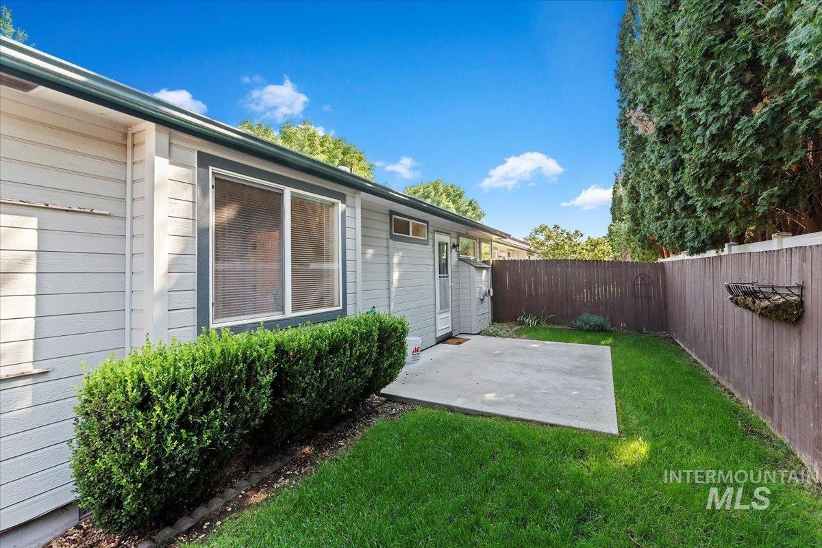 Fenced backyard featuring a patio