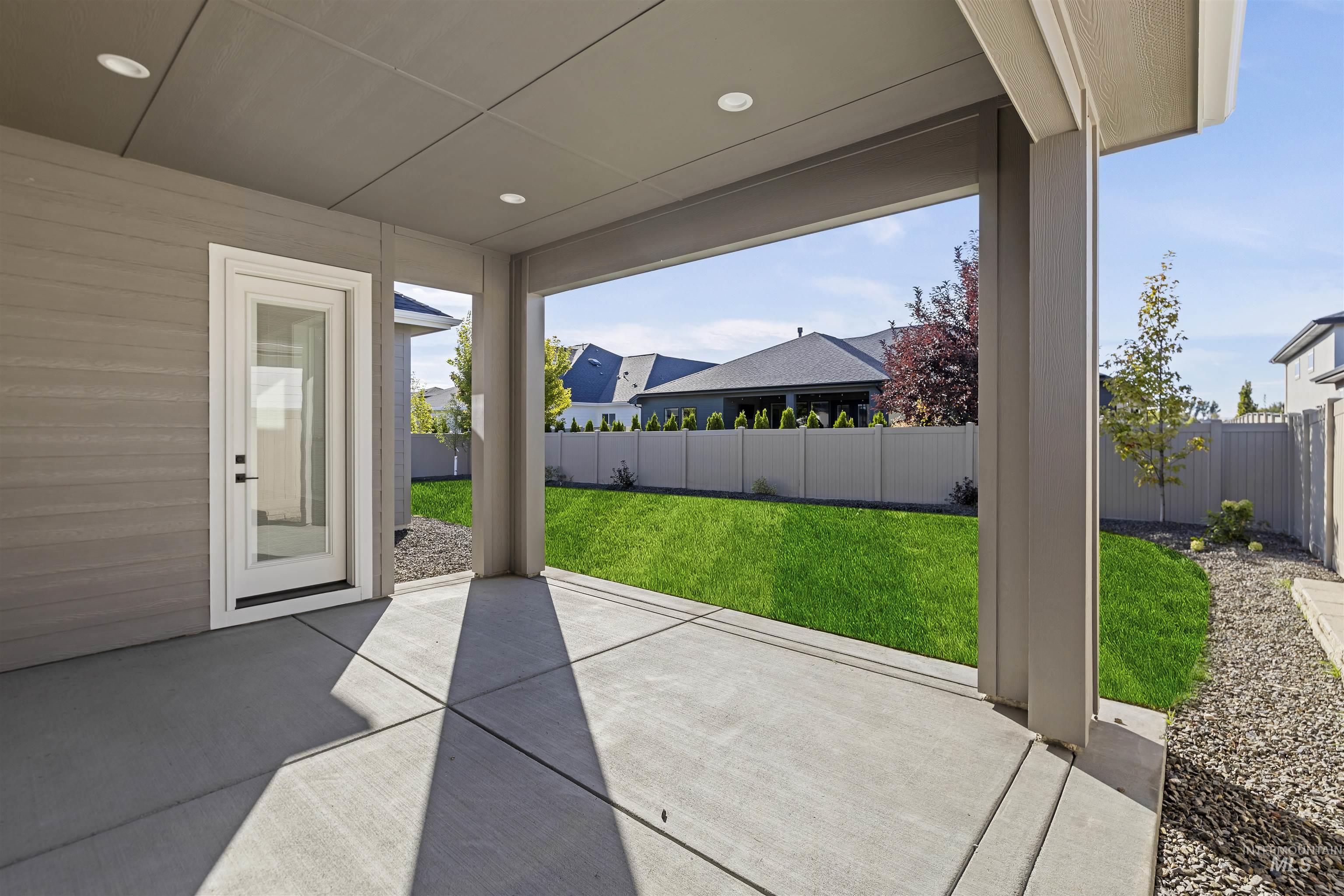 Fenced backyard with a rear covered patio area