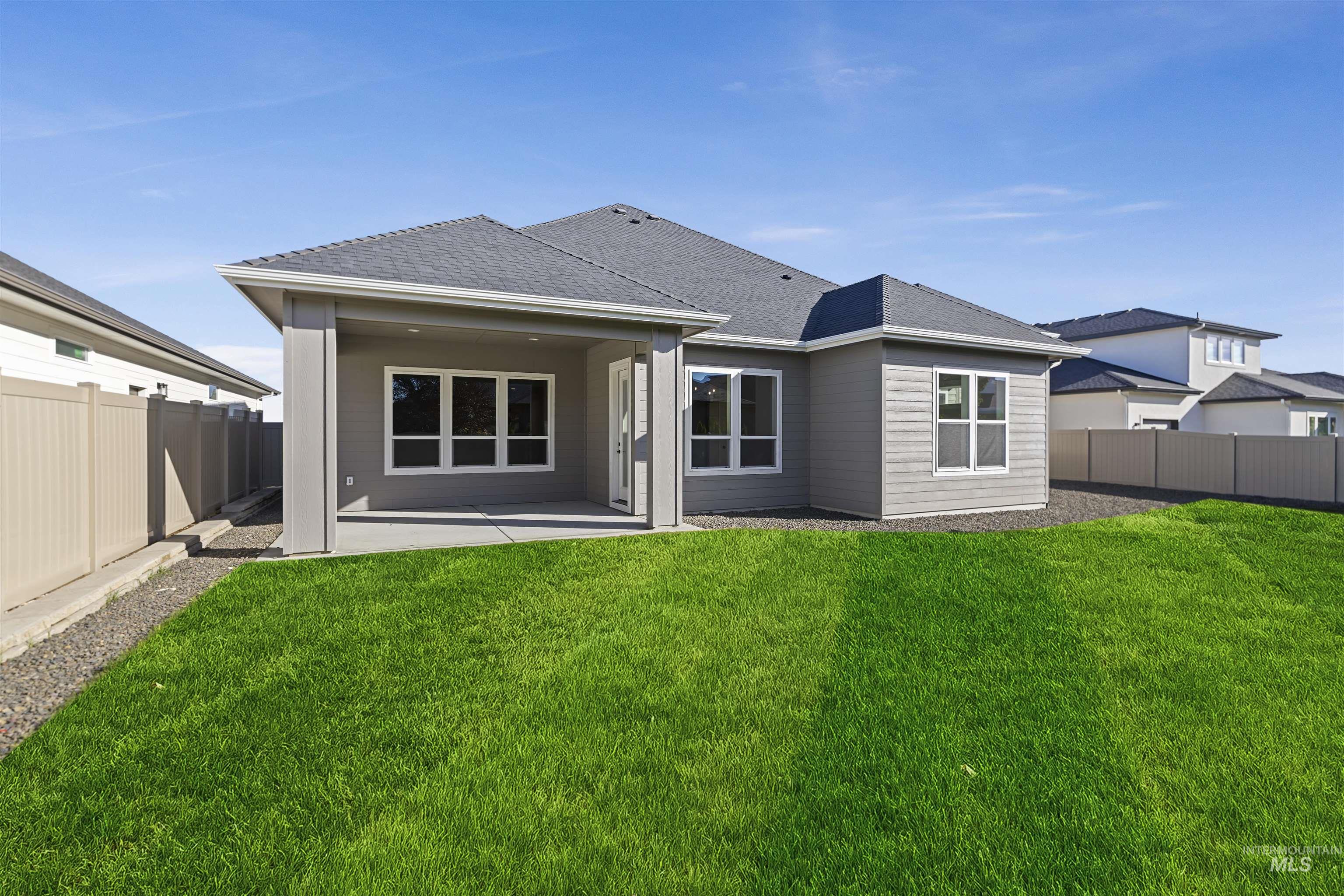 Back of house with a patio, a fenced backyard, and roof with shingles