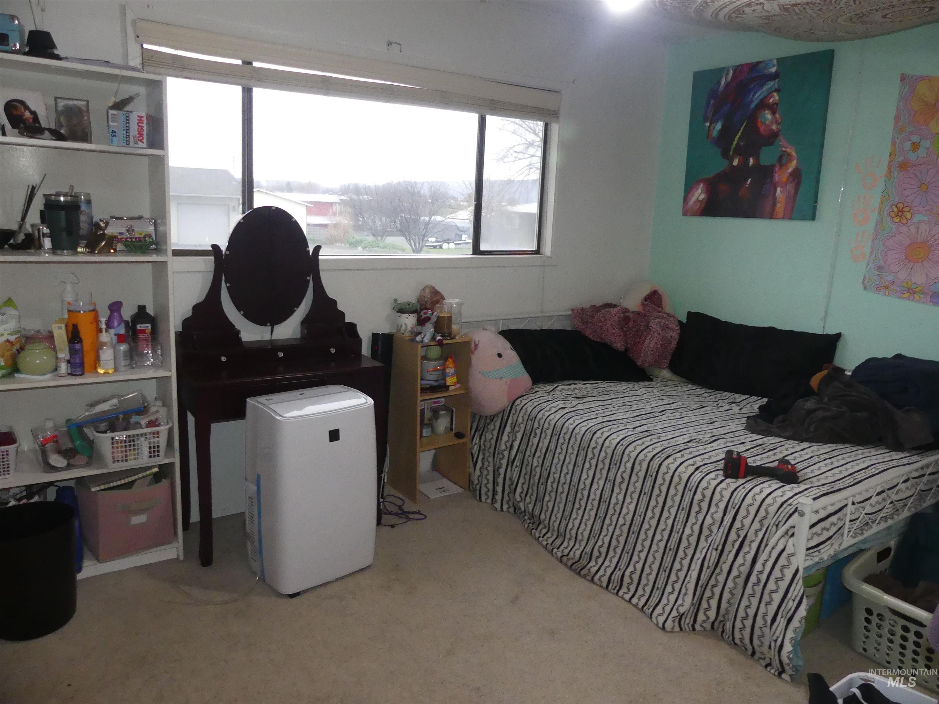 Bedroom featuring light colored carpet