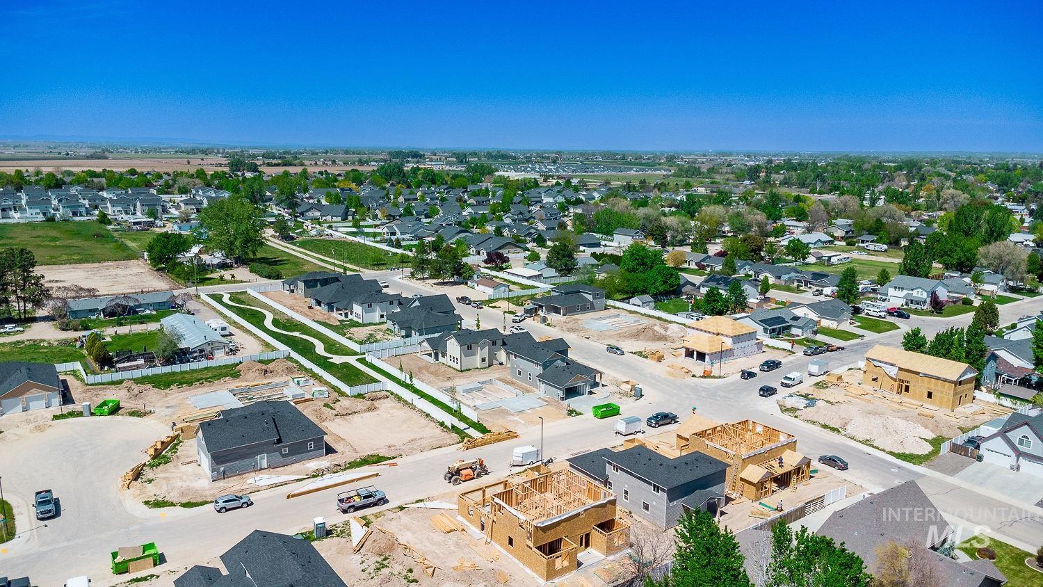Aerial perspective showcasing a developing residential community with a mix of completed homes and properties under construction