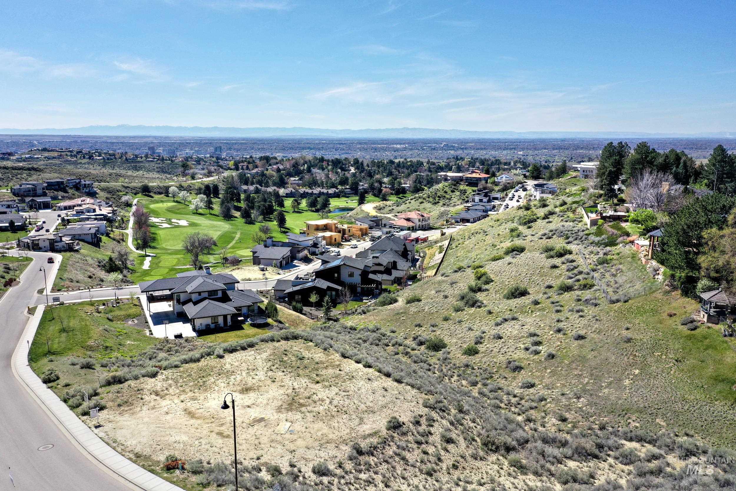 Aerial perspective of suburban area featuring a golf course
