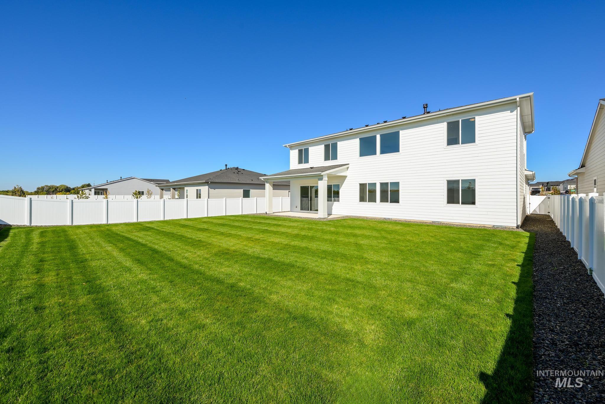 Rear view of property featuring a patio and a fenced backyard