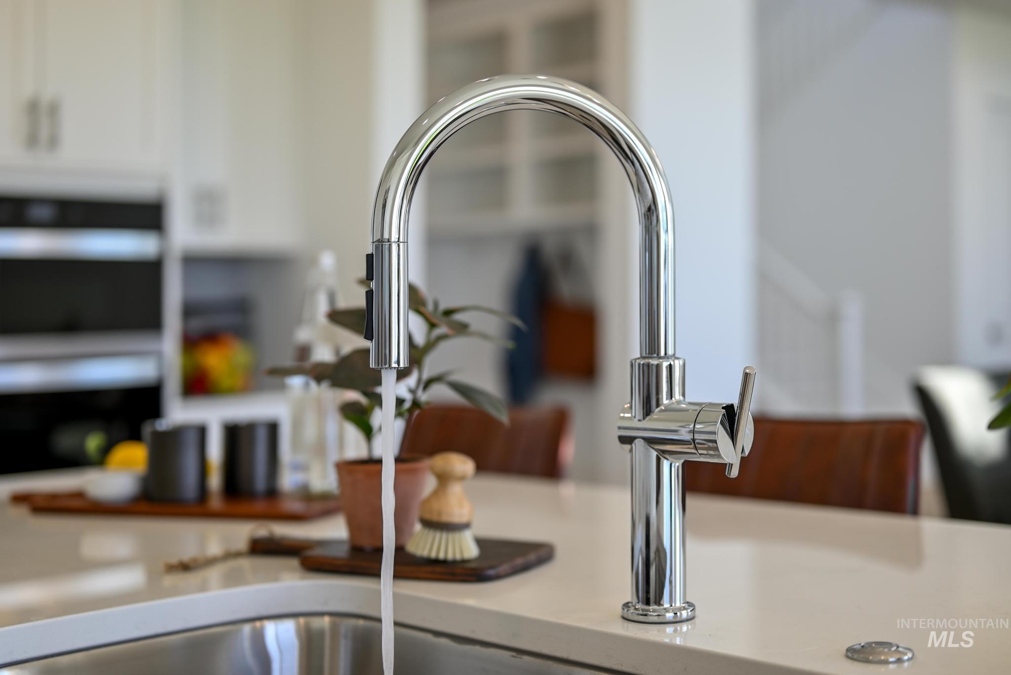 Kitchen view of a sink and light countertops