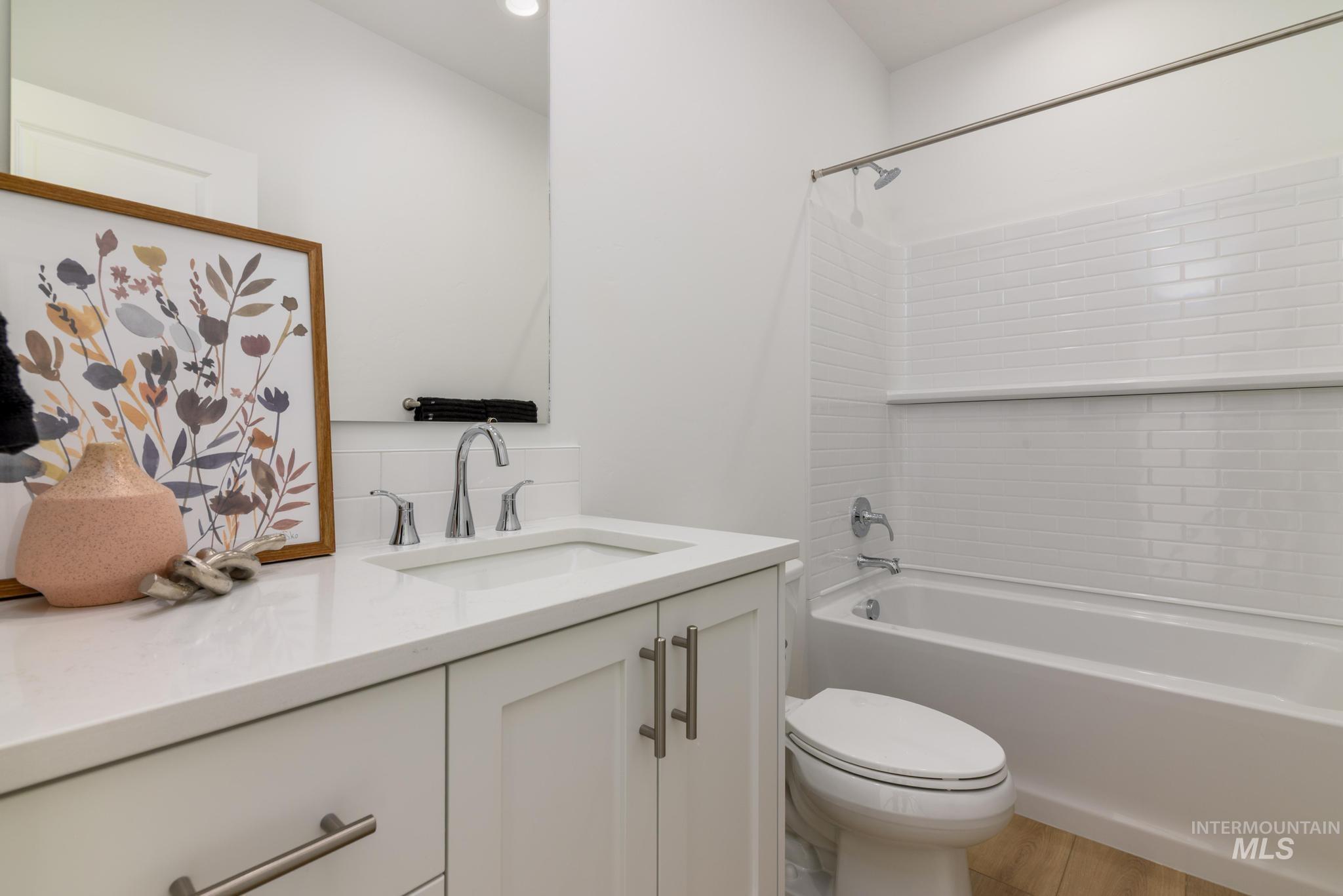 Bathroom featuring bathtub / shower combination and vanity
