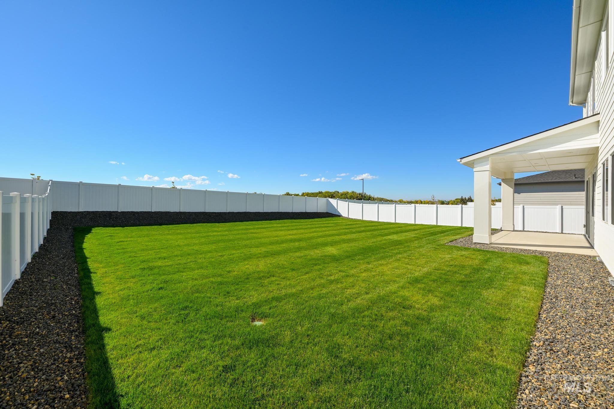 Fenced backyard with a patio area