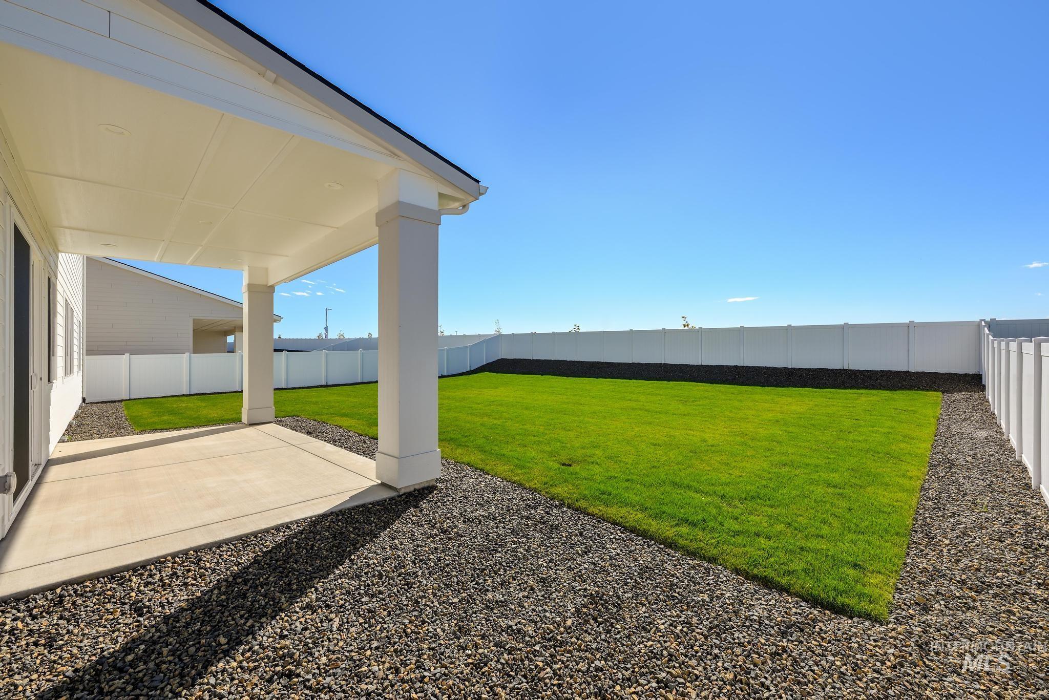 Fenced backyard featuring a patio