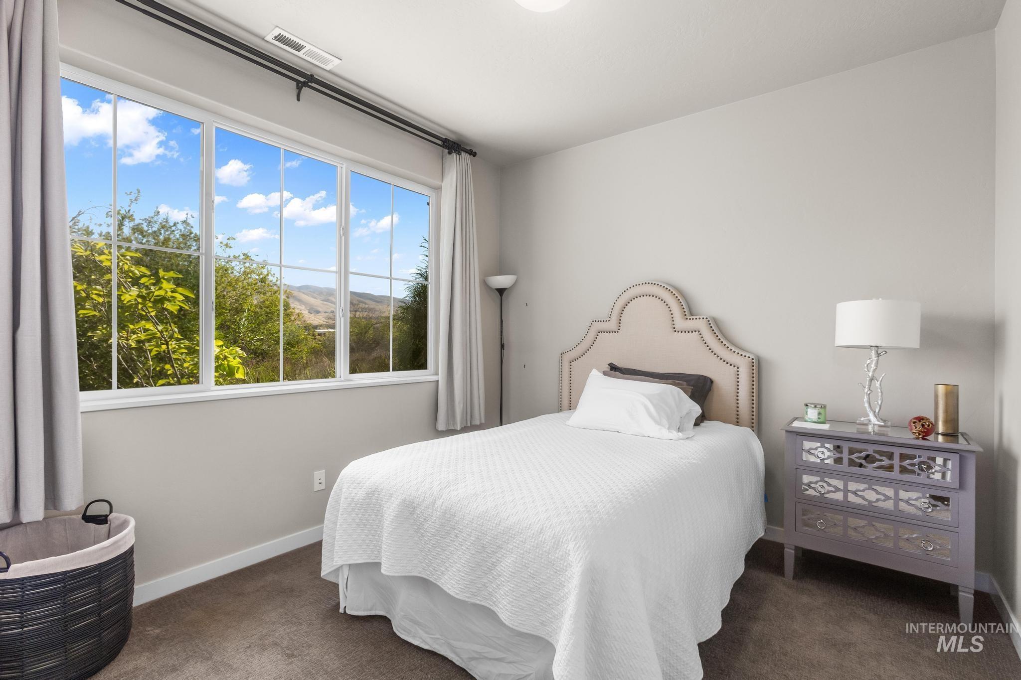 Bedroom featuring dark carpet and a mountain view