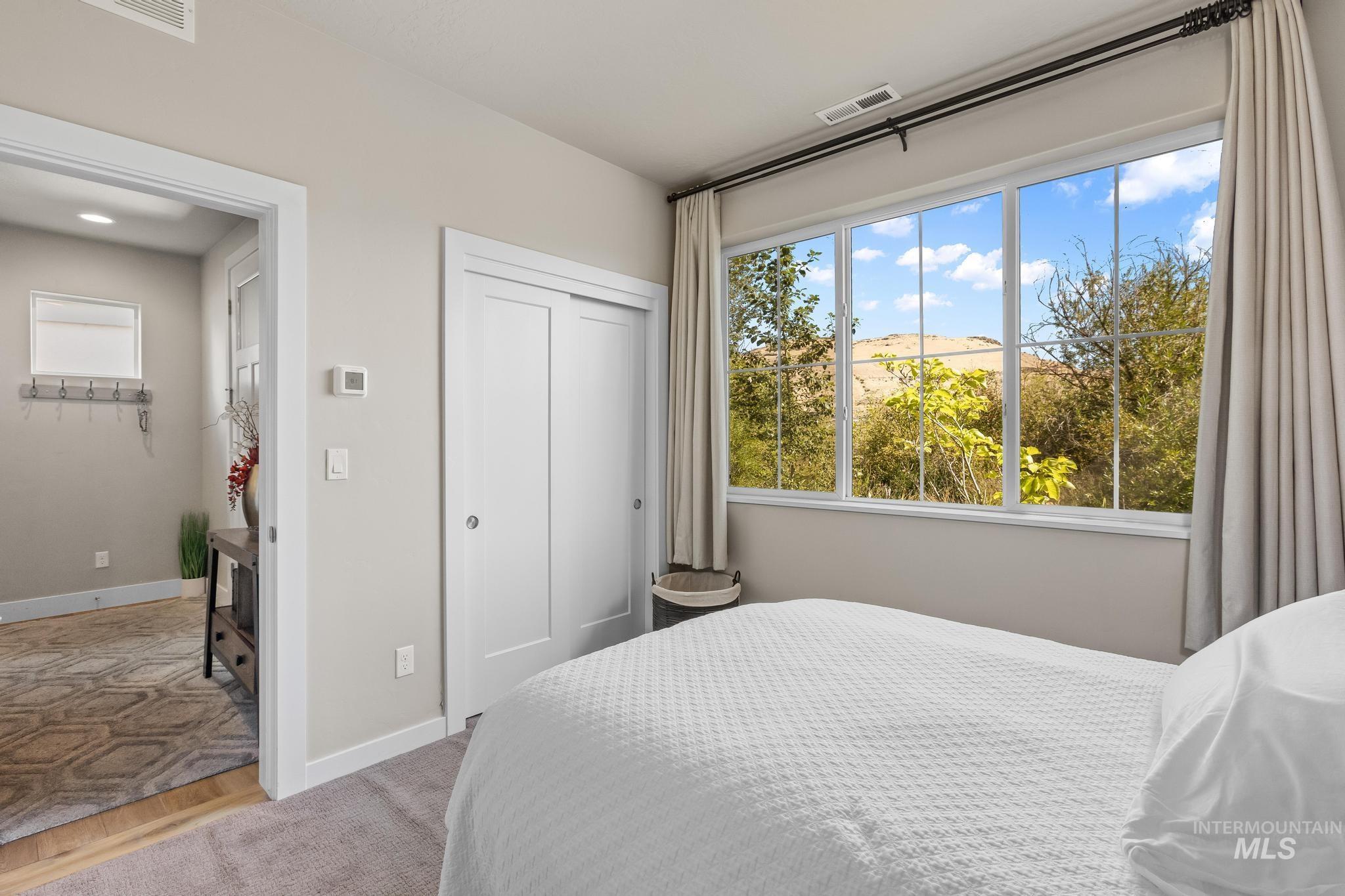 Bedroom with a closet, wood finished floors, and a mountain view
