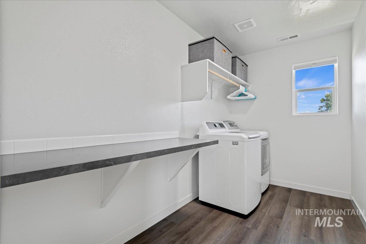 Laundry room with independent washer and dryer and engineered vinyl plank-type flooring