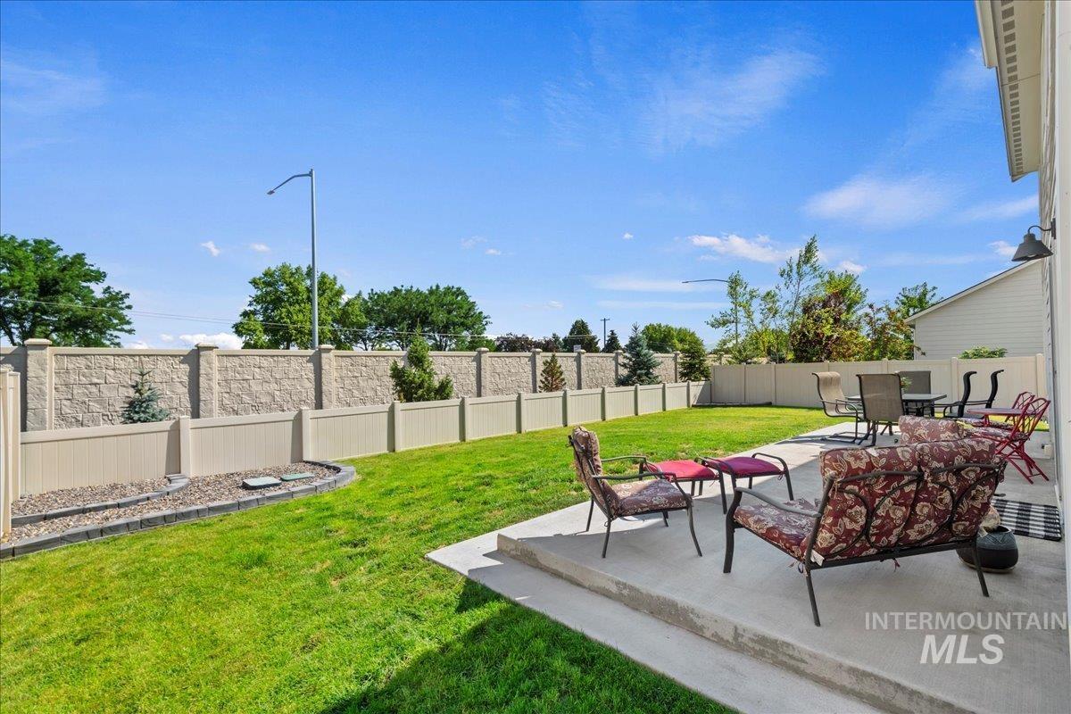 Fenced backyard with a patio and outdoor dining area