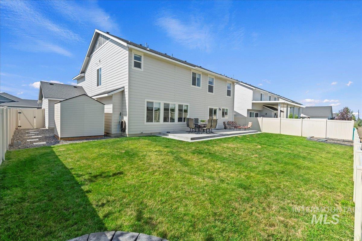 Rear view of property with a patio area and a fenced backyard