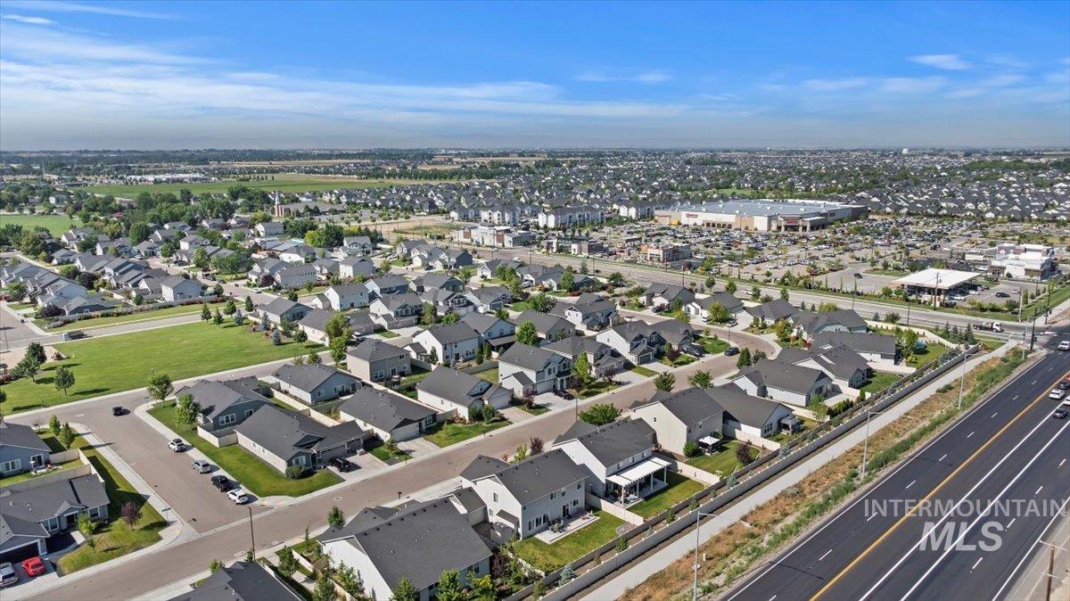 Aerial view of property and surrounding area with nearby suburban area