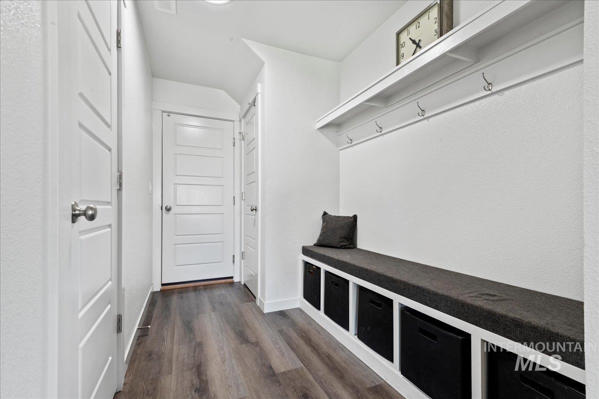 Mudroom featuring engineered vinyl plank-type flooring and baseboards