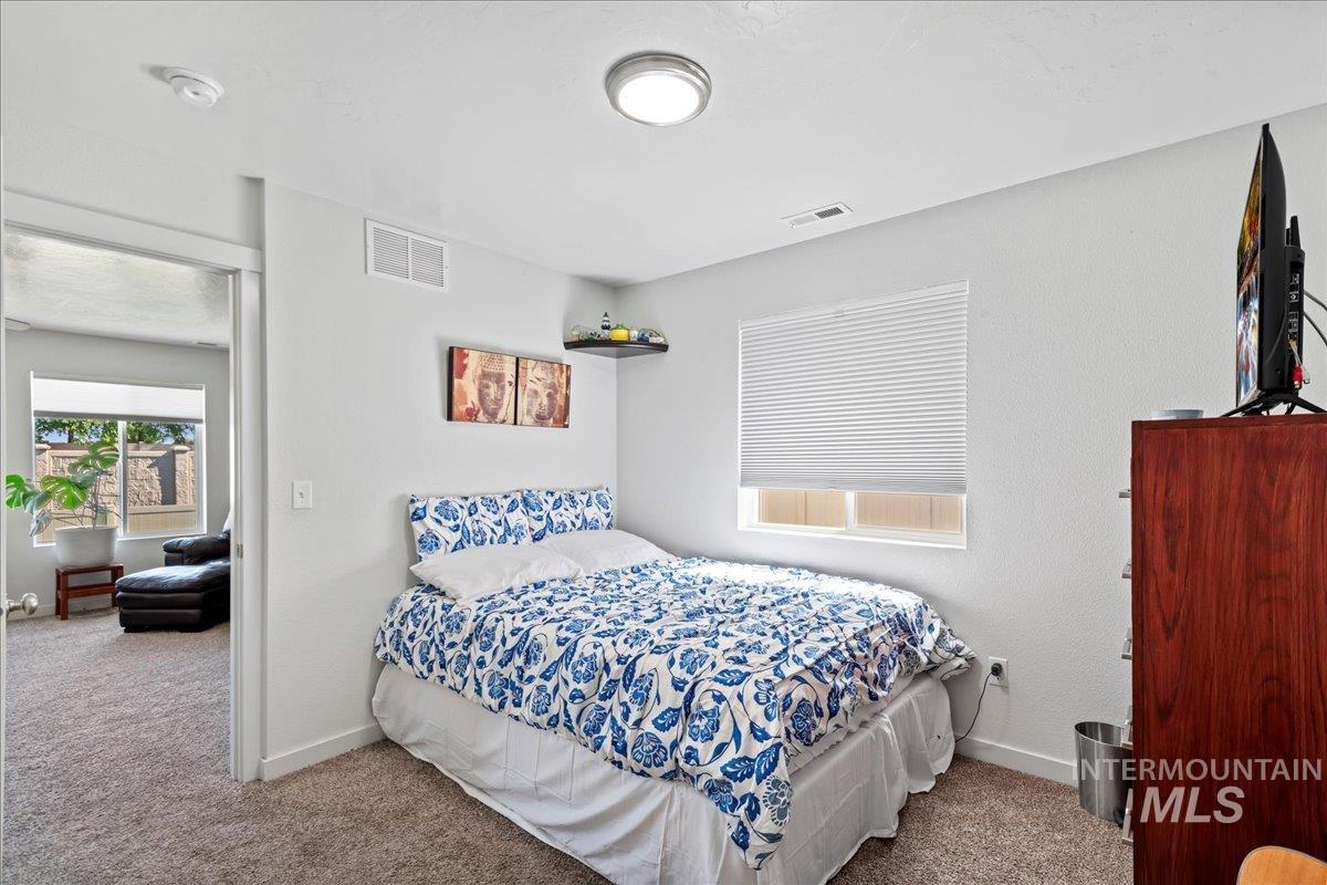 Bedroom featuring carpet flooring and baseboards