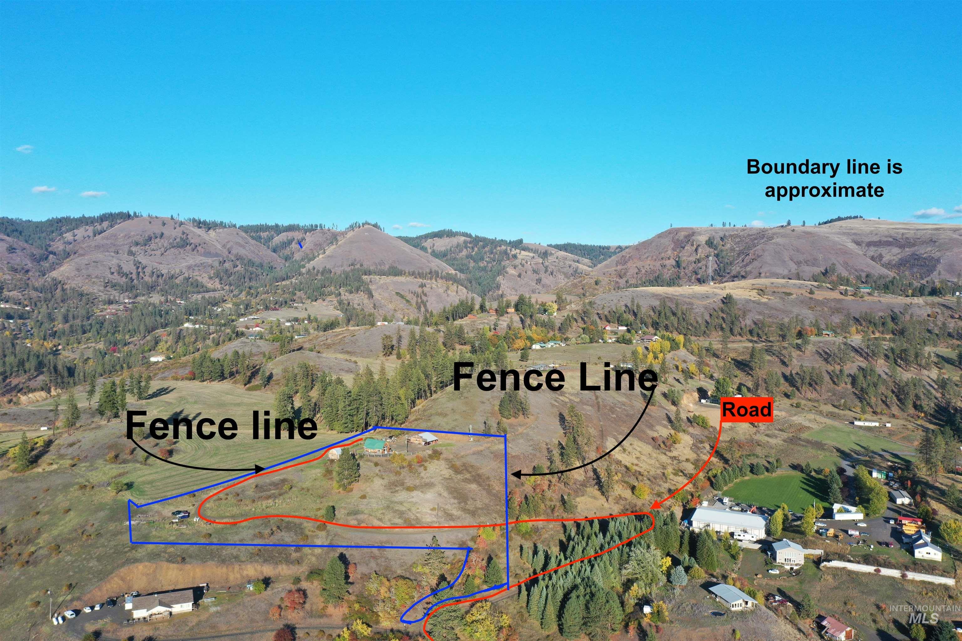 Aerial view of property's location featuring a mountainous background and property boundaries highlighted