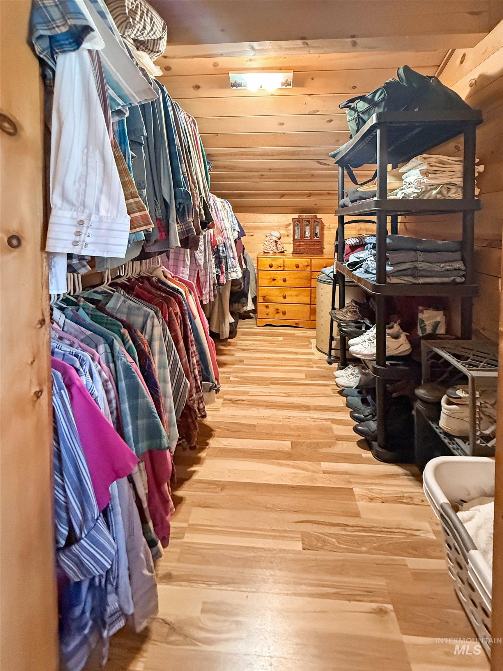 Spacious closet featuring light wood-style floors