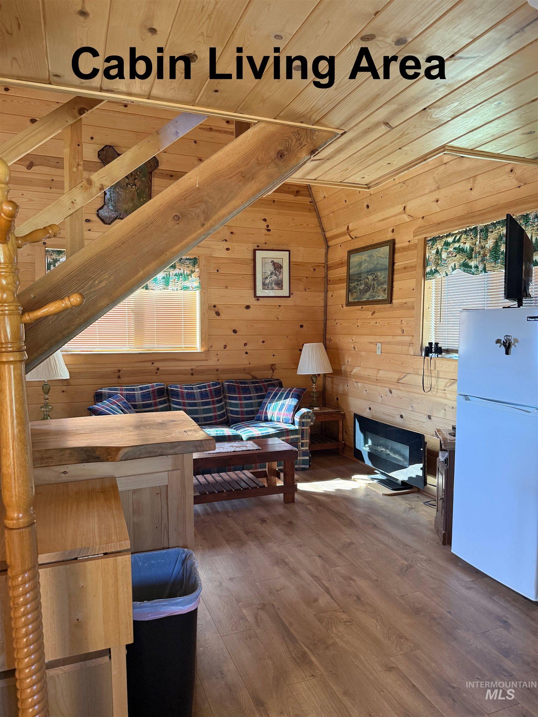 Additional living space with wood finished floors, wooden ceiling, wooden walls, and vaulted ceiling