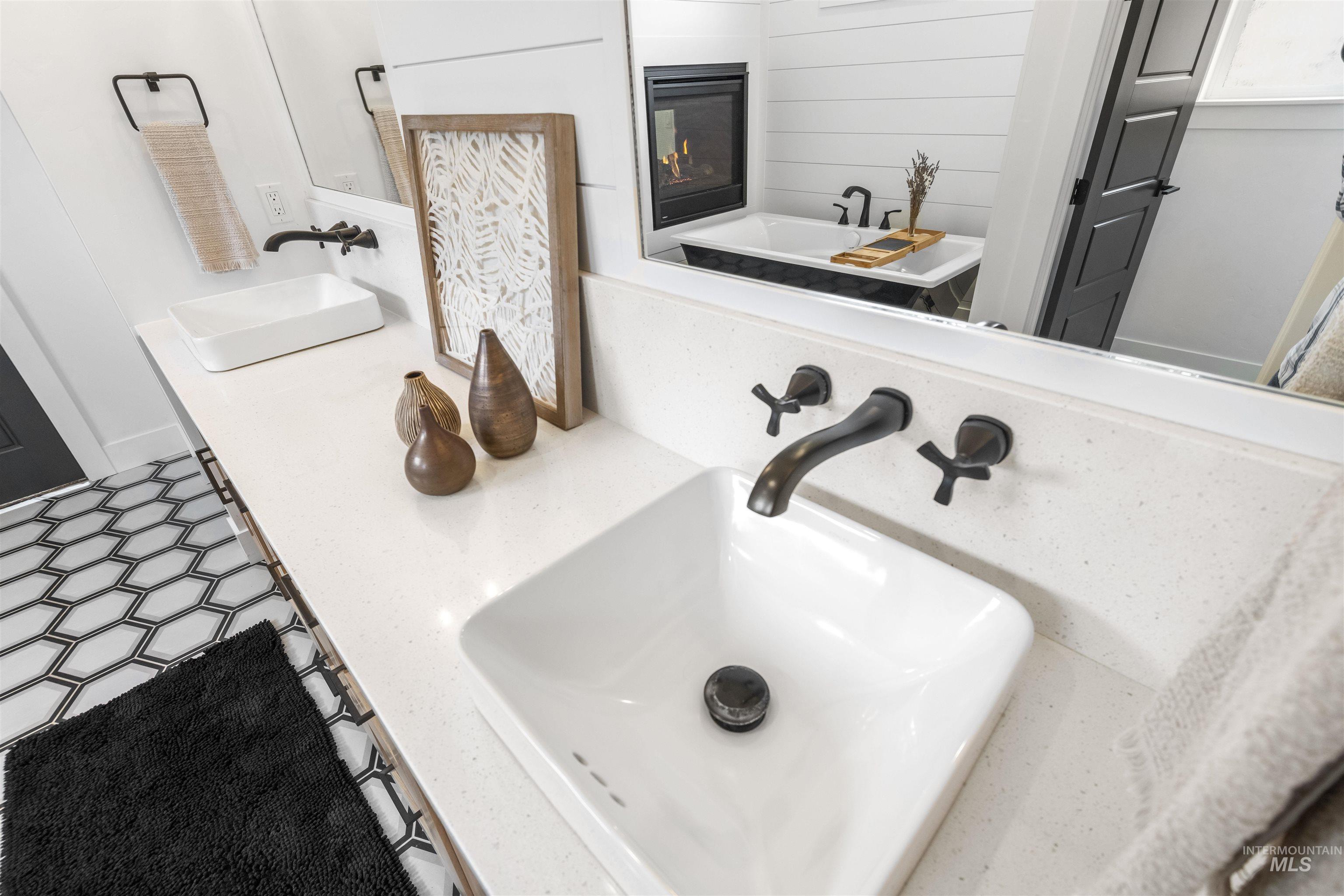 Bathroom view of double vanity and tile patterned floors