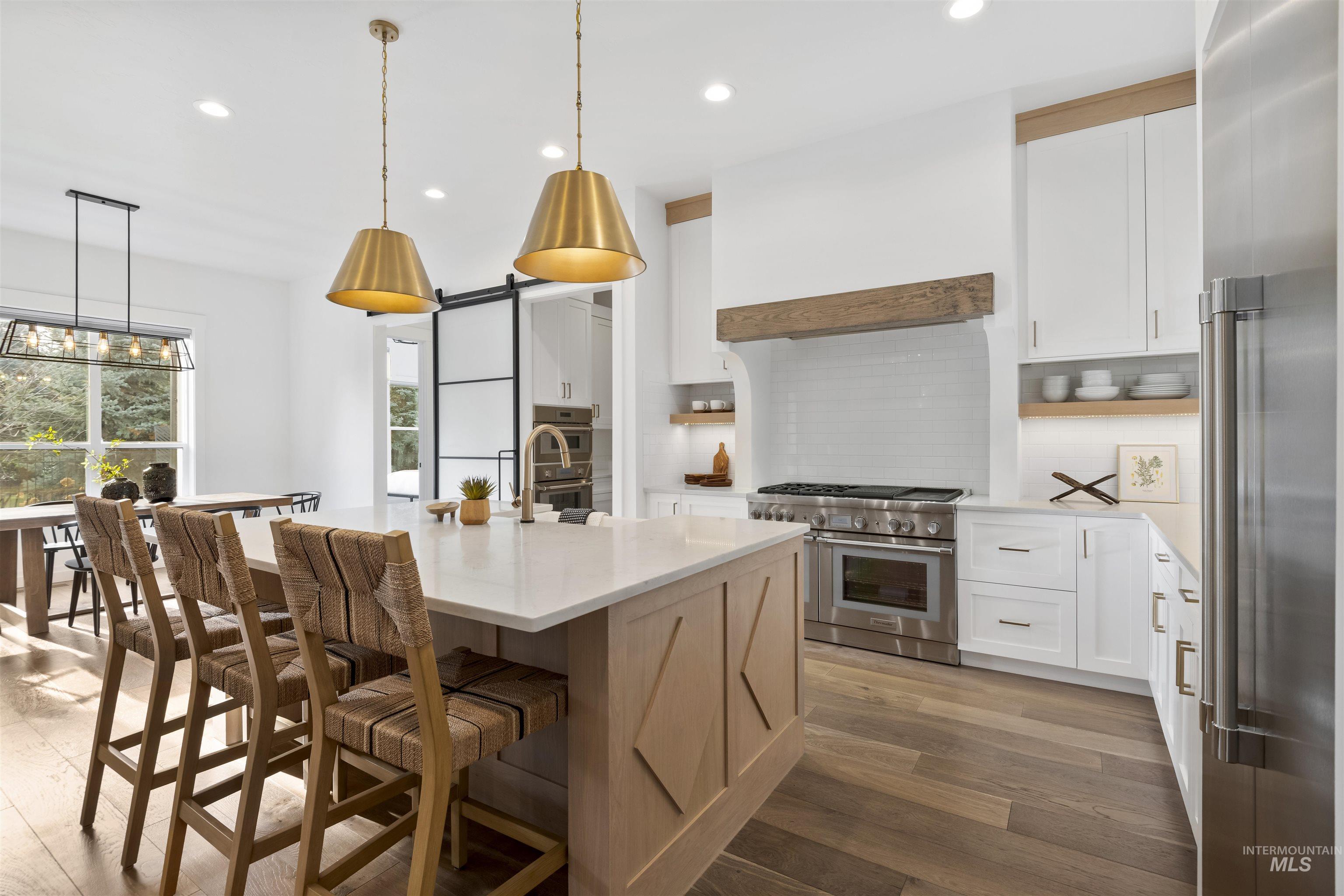 Kitchen with white cabinets, backsplash, open shelves, and recessed lighting