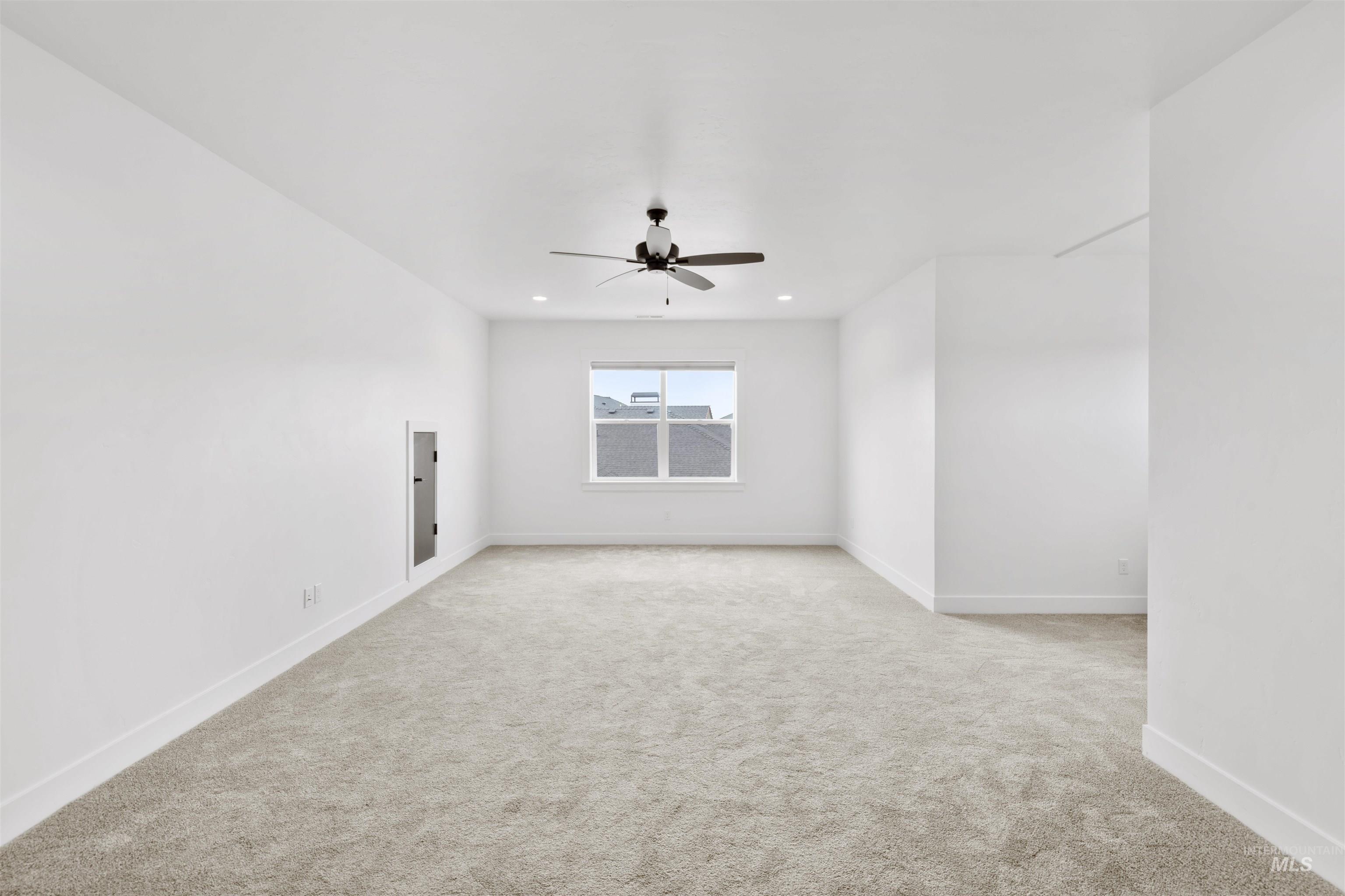 Empty room featuring light carpet, a ceiling fan, and recessed lighting