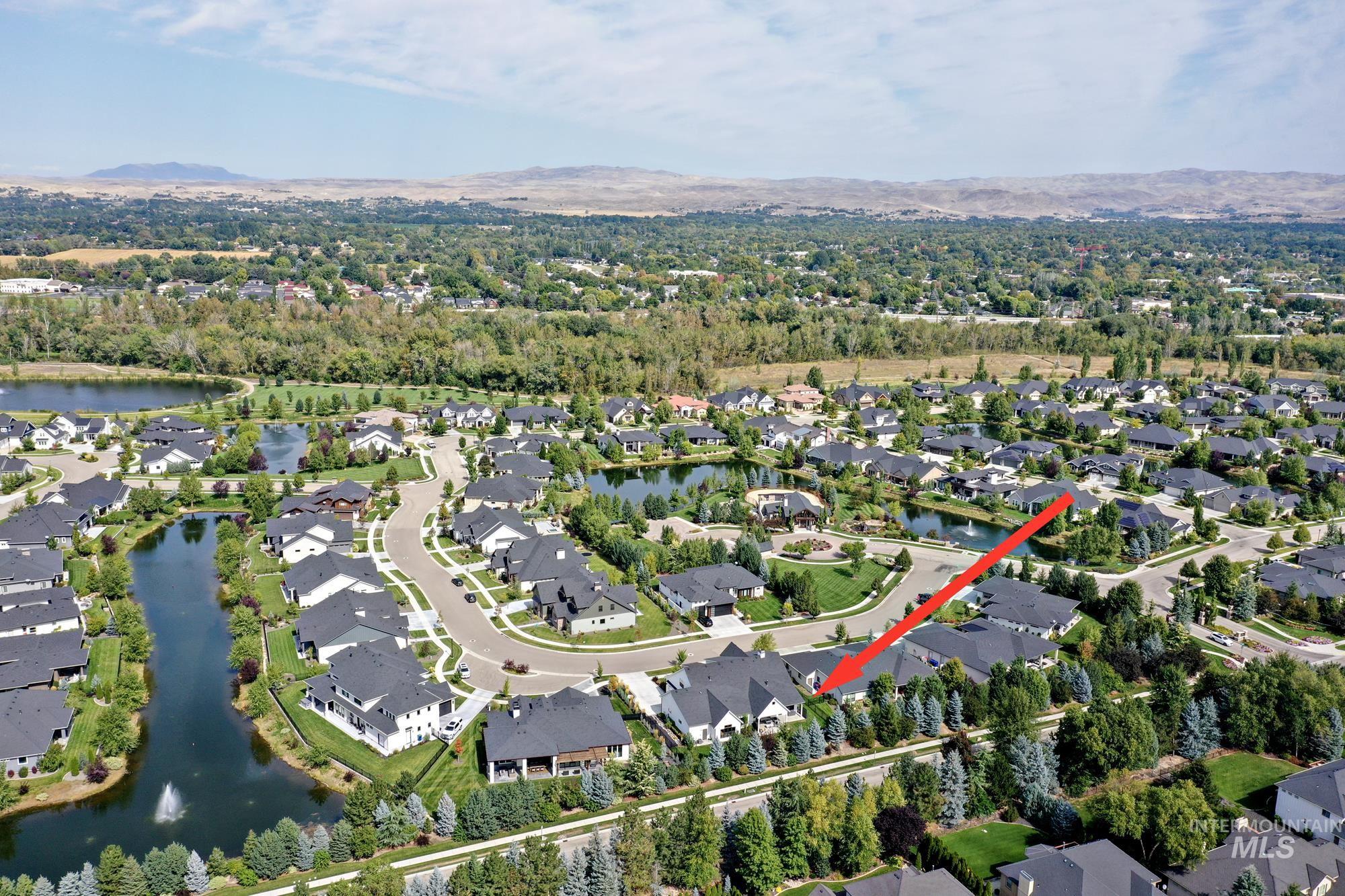 Aerial view of property's location with nearby suburban area and a water and mountain view